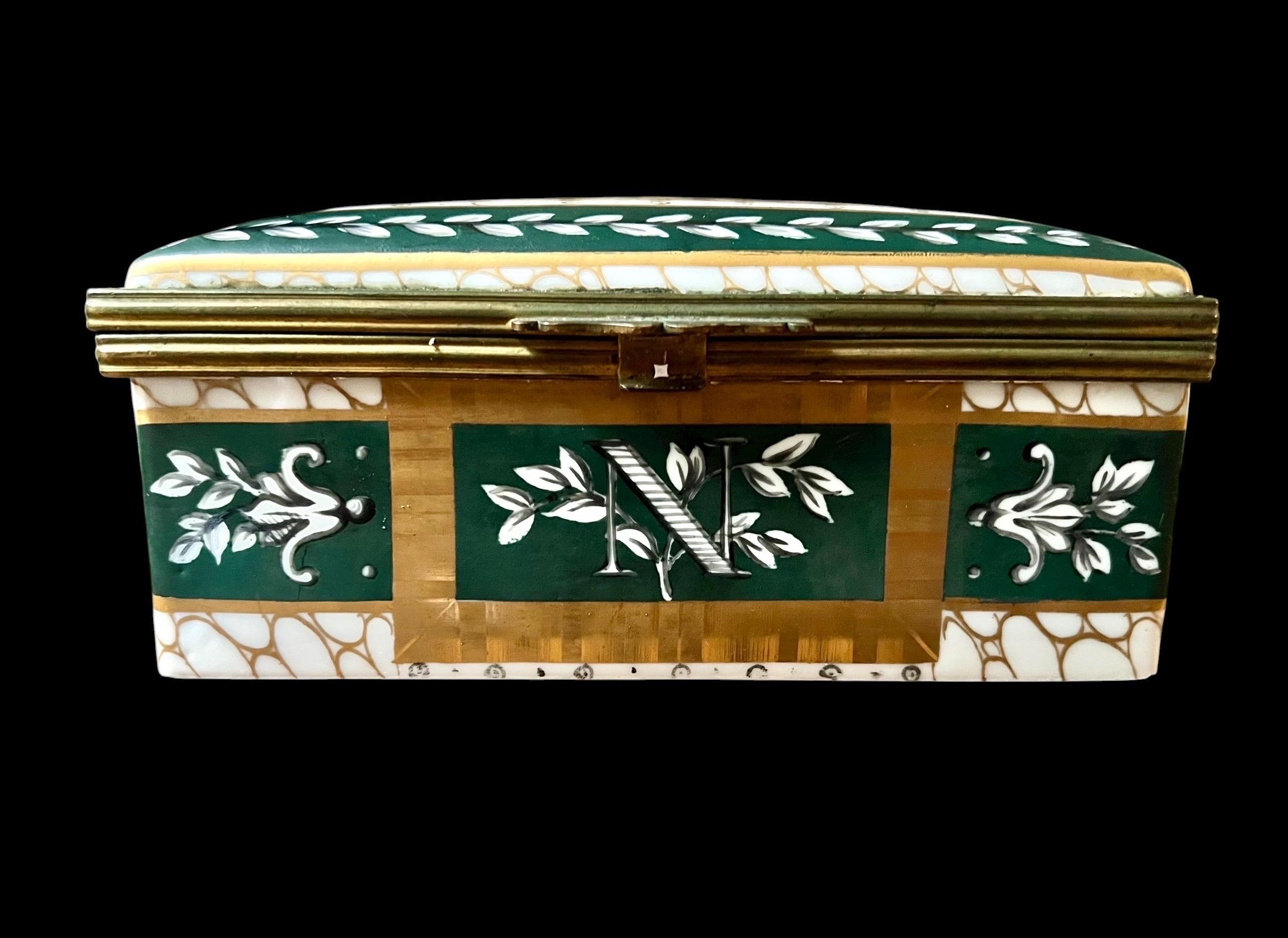 A very beautiful rectangular box made of fine porcelain, decorated in the imperial style of the First Empire. The decoration, dominated by green and gold tones, illustrates the refinement of Napoleonic aesthetics.

The lid is adorned with a crested