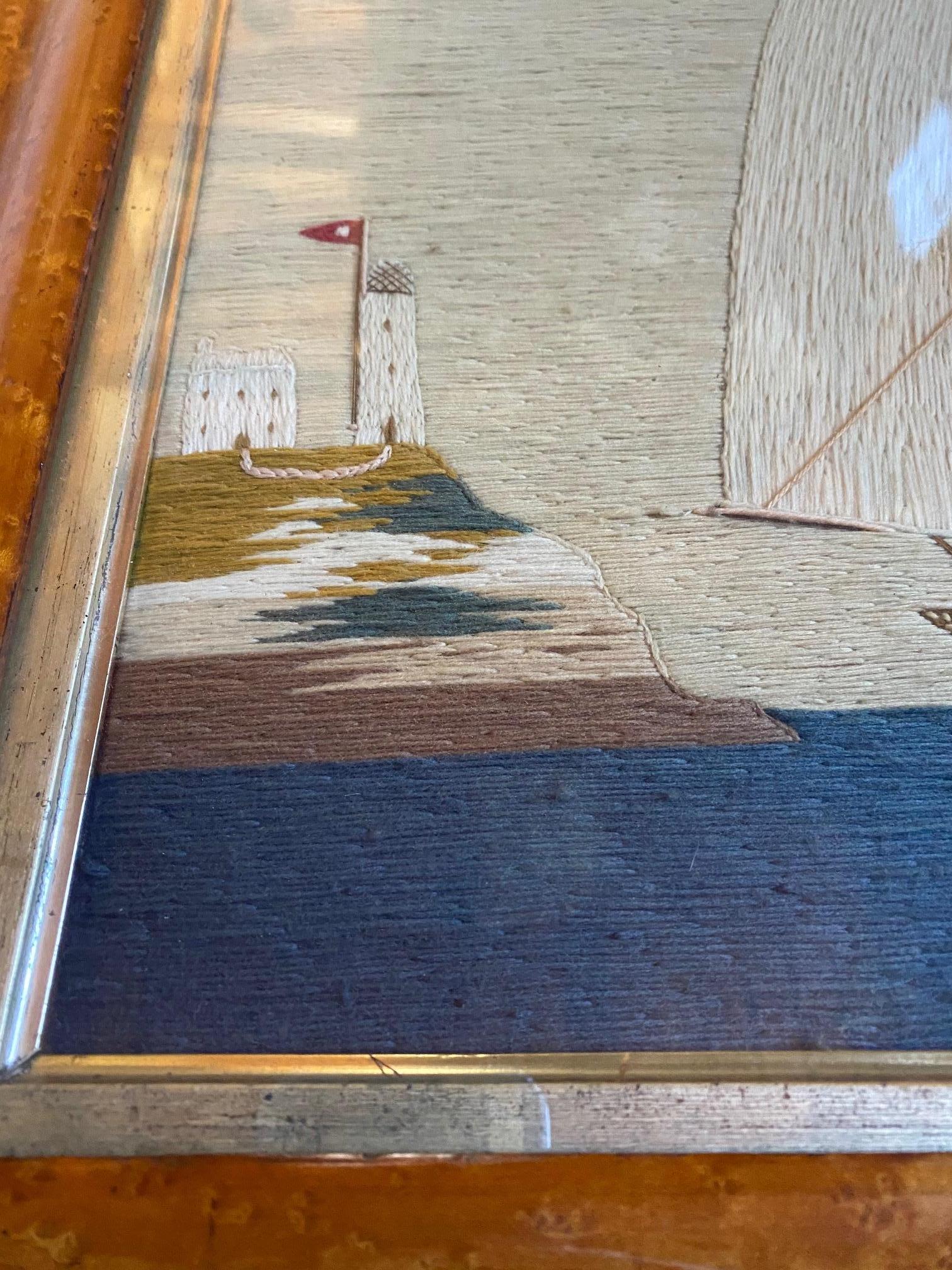 19th century Trinity House Sailor's Woolwork Embroidery, British, circa 1870, a sailor's folk art hand stitched wool yarn embroidered picture of a schooner under full sail, flying a Number Four pennant on the Main Topmast, and the Red Ensign on the