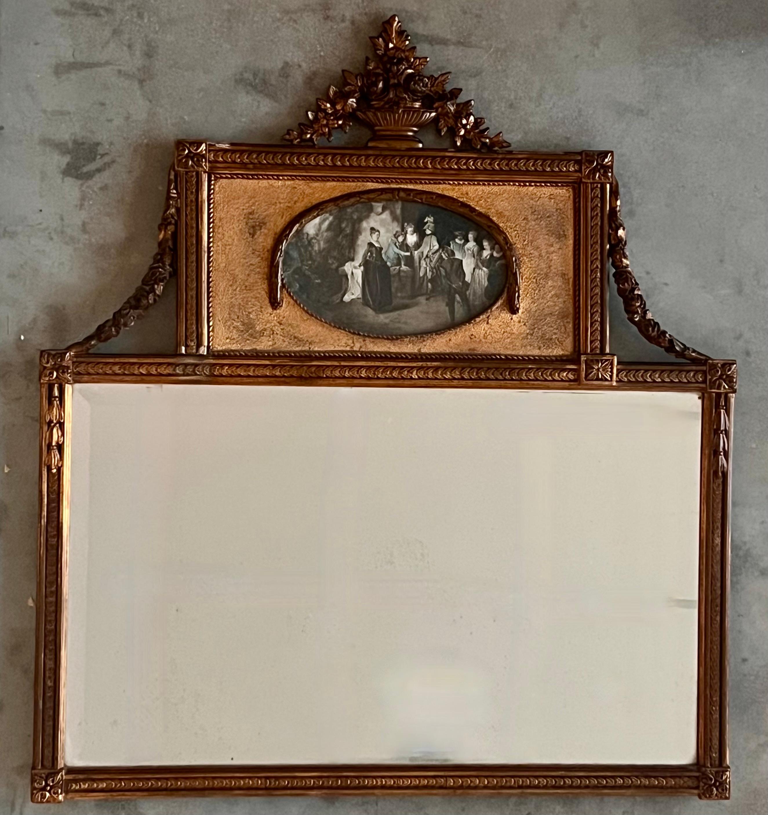 A fine Louis XVI style trumeau wall mirror in wood and gilded stucco. Its upper section features an oval-shaped reproduction of an original colour engraving of an 18th-century pastoral scene, enclosed within delicate pearl beading and topped with a