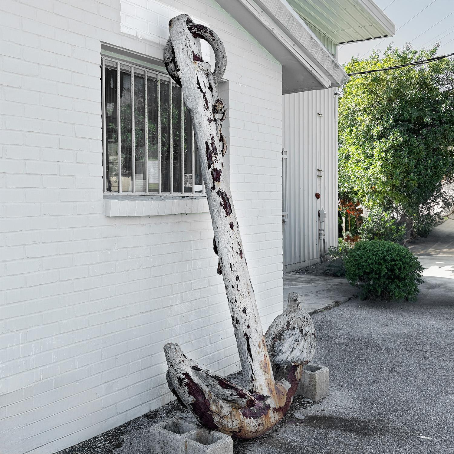 A massive, antique Turkish anchor made of cast iron, in good condition. The large detailed metal décor piece was recovered from the ocean floor, 80 miles south of Izmir. Encrusted with barnacles and sea matter, partial chain attached. Minor loses,