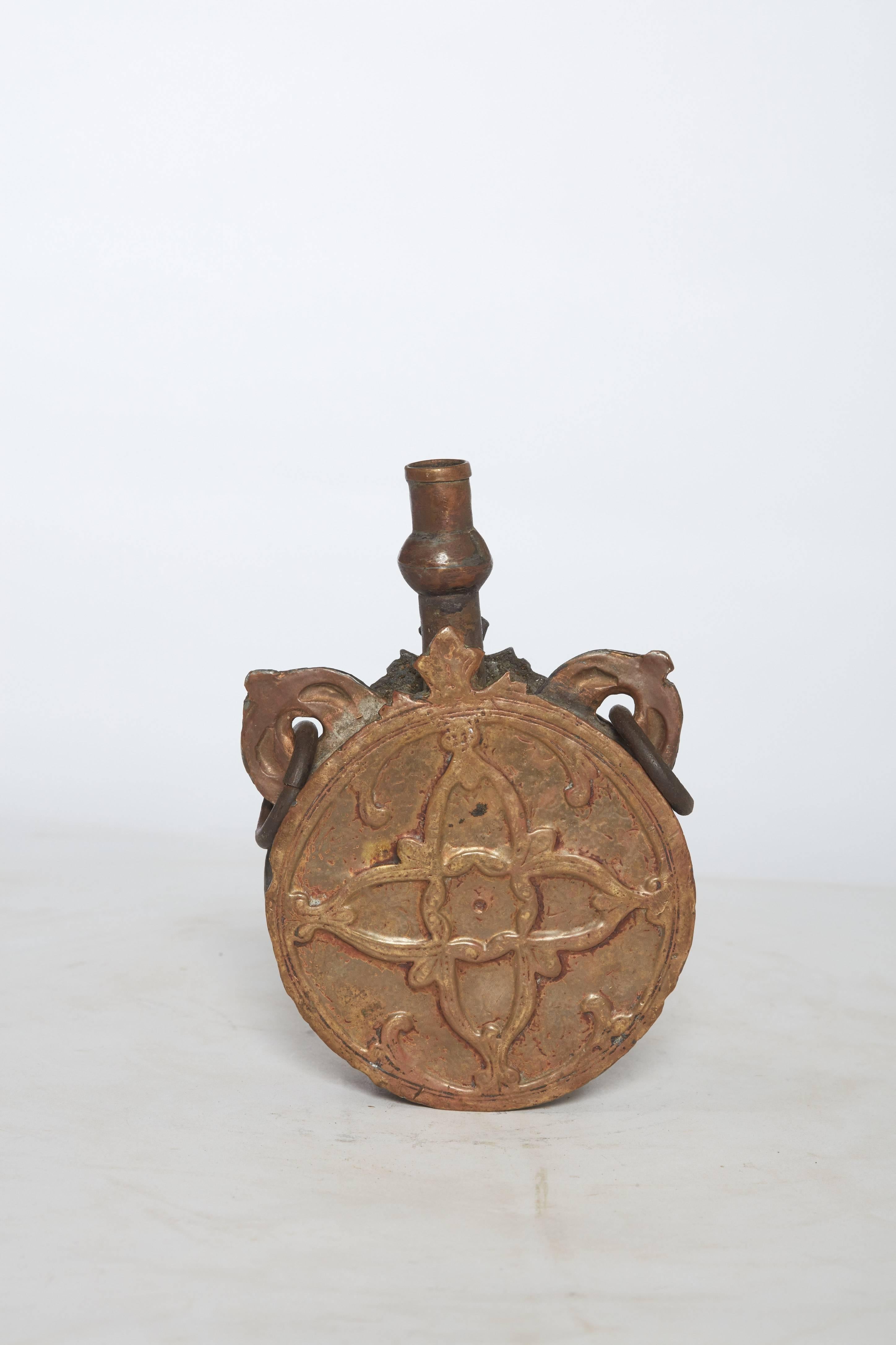 19th century Turkish bronze vessel/flask with ornate detailing



Dimensions: 6.63 in. H total; body of piece is 5 in H x 4.25 in W (circular part). The hooks are 1 in. up from the circular part.