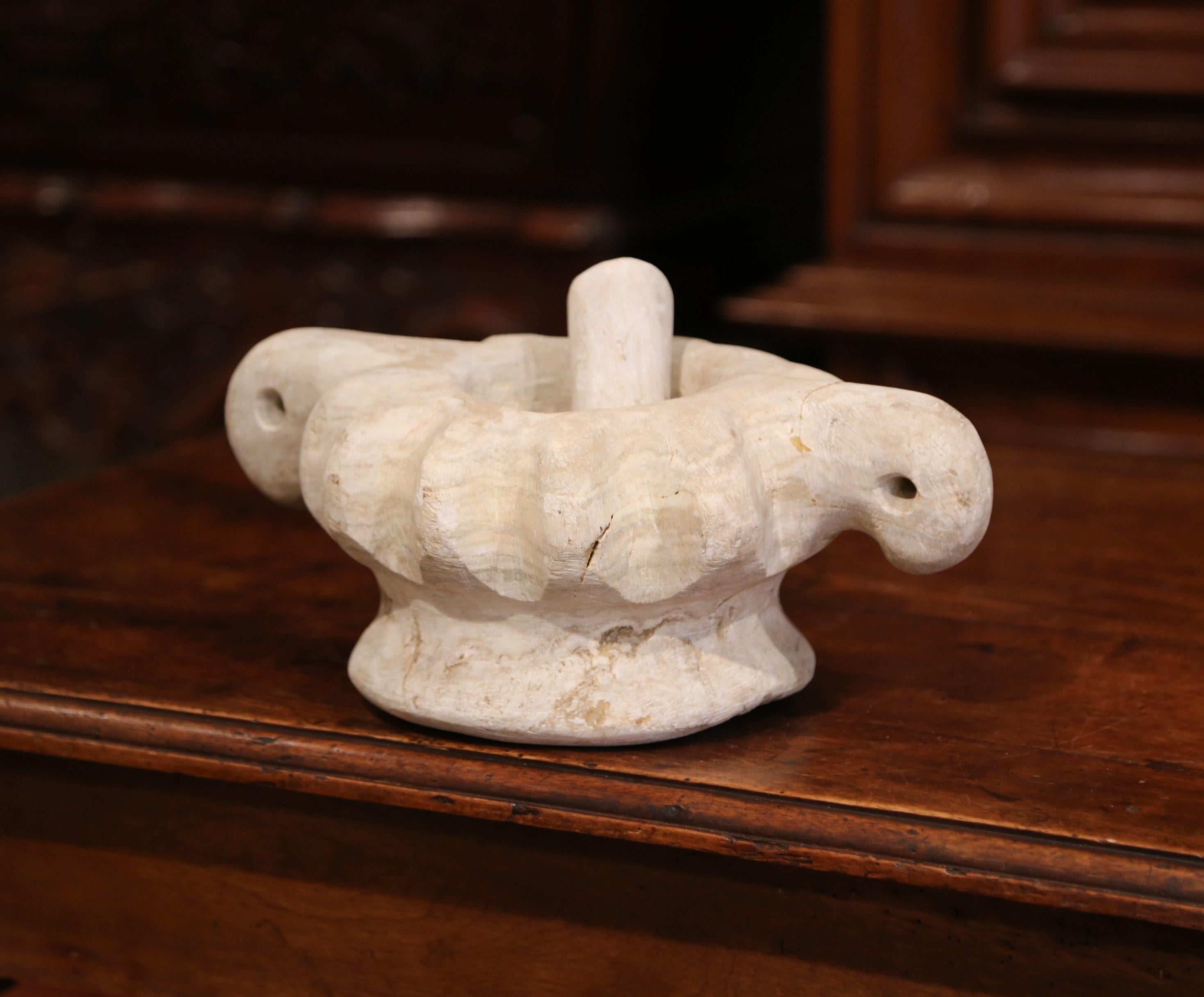 Grind spices in your kitchen with this hand carved, antique white stone mortar. Created in Turkey, circa 1880, this traditional mortar and pestle is round in shape and has a shell-like scalloped detail. The cooking tool is in very good condition