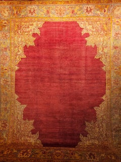 Oushak turc du 19ème siècle avec un motif de champ ouvert en rouge, turquoise et jaune
