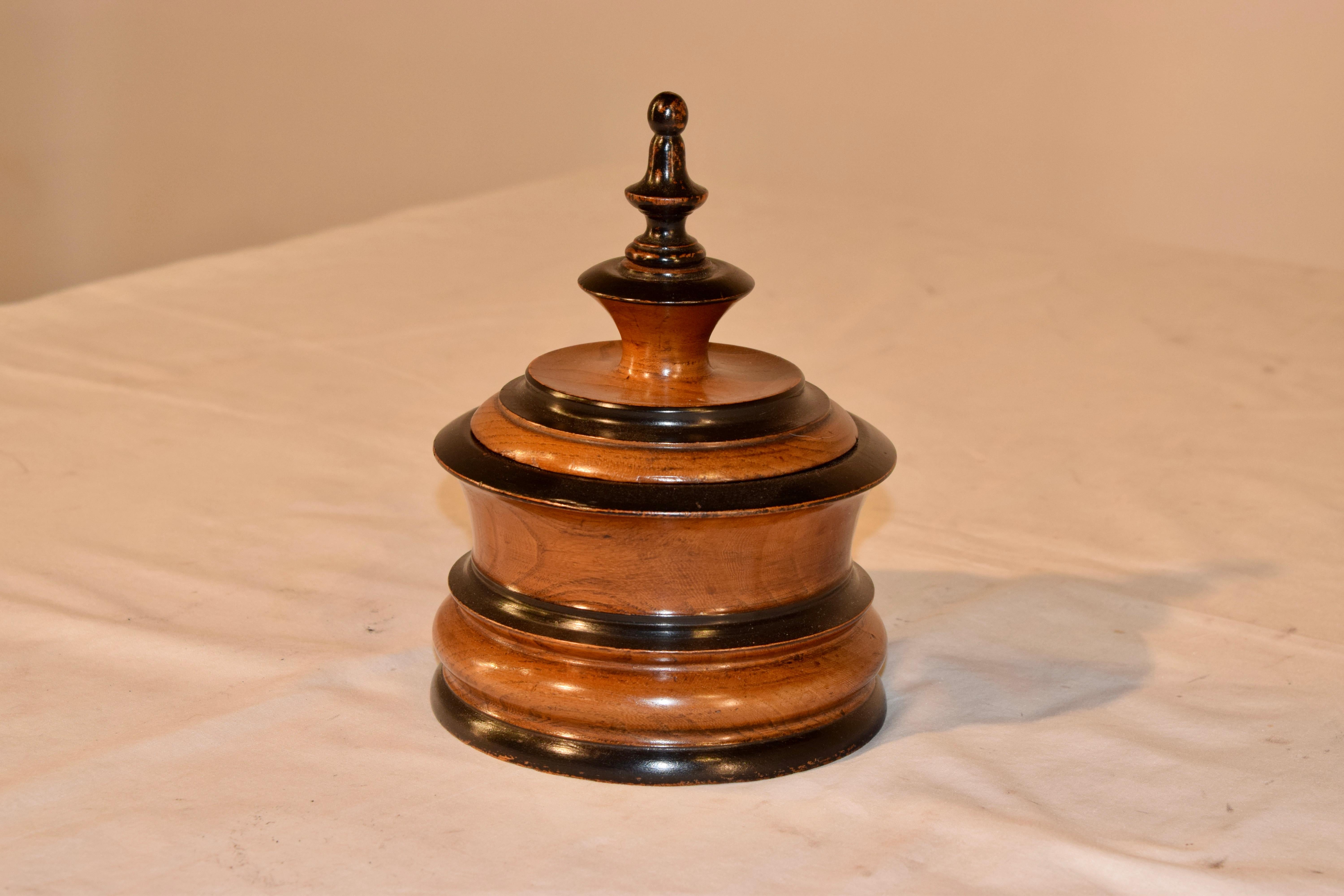 19th century hand turned treen humidor from the Netherlands. The jar is made from fruitwood and has been wonderfully hand turned and thoughtfully ebonized to accent the turned pattern. The lid is finished with a tall finial.