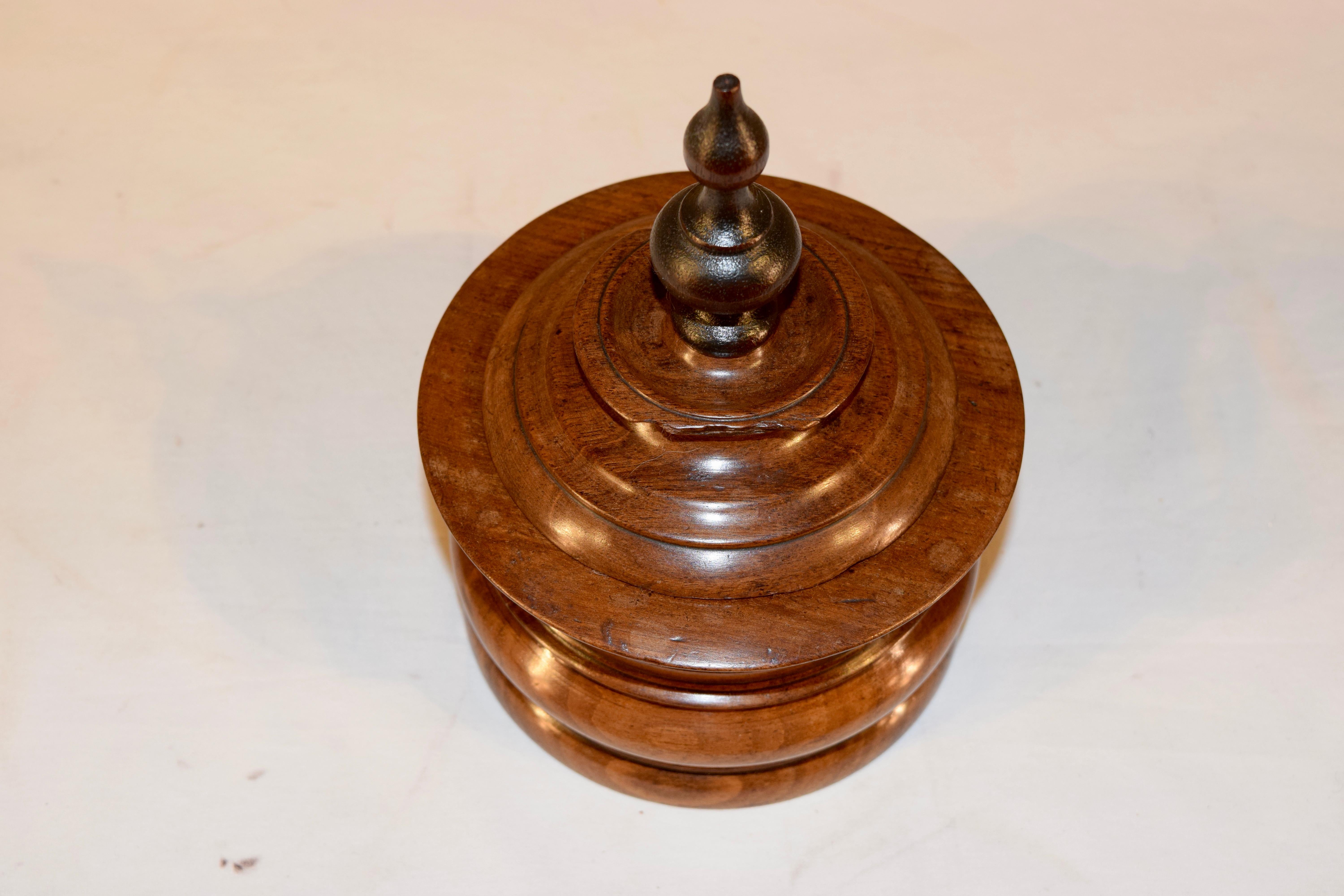 19th century turned walnut humidor with lovely shaping and retaining the original interior press and old losses to the top. Beautiful patina and wear.