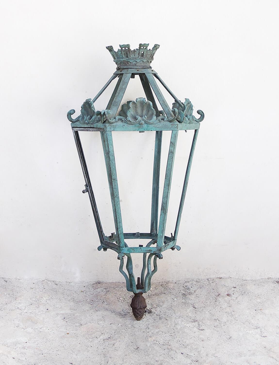 Salvaged from a castle here in Tuscany, this wonderful 19th century wrought iron metal lantern has shell and castellated motifs. The front of the lantern has a working door which opens to replace a candle or lightbulb. This piece would look amazing