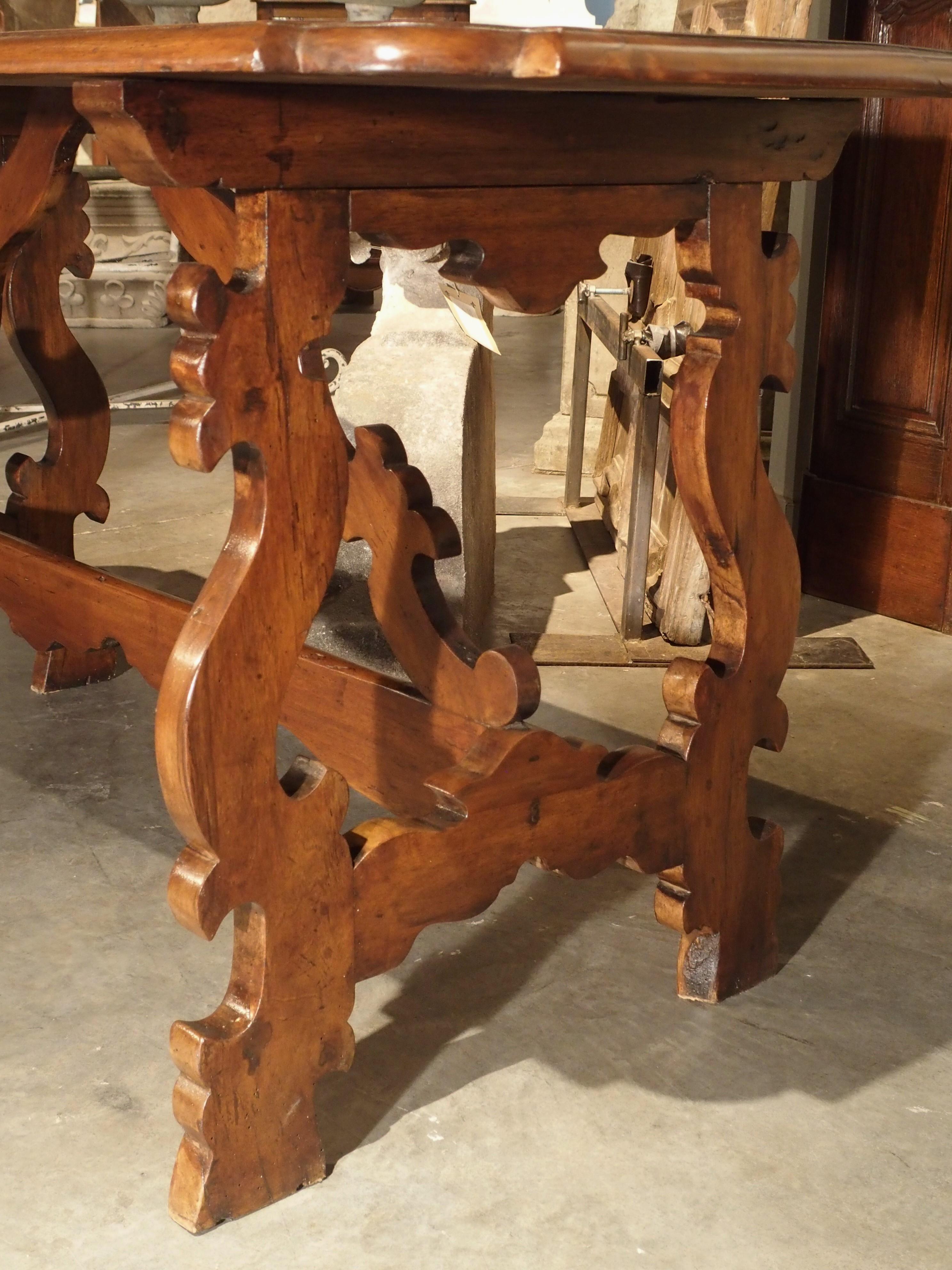 Hand-Carved 19th Century Tuscan Walnut Table with Shaped Wooden Stretchers For Sale