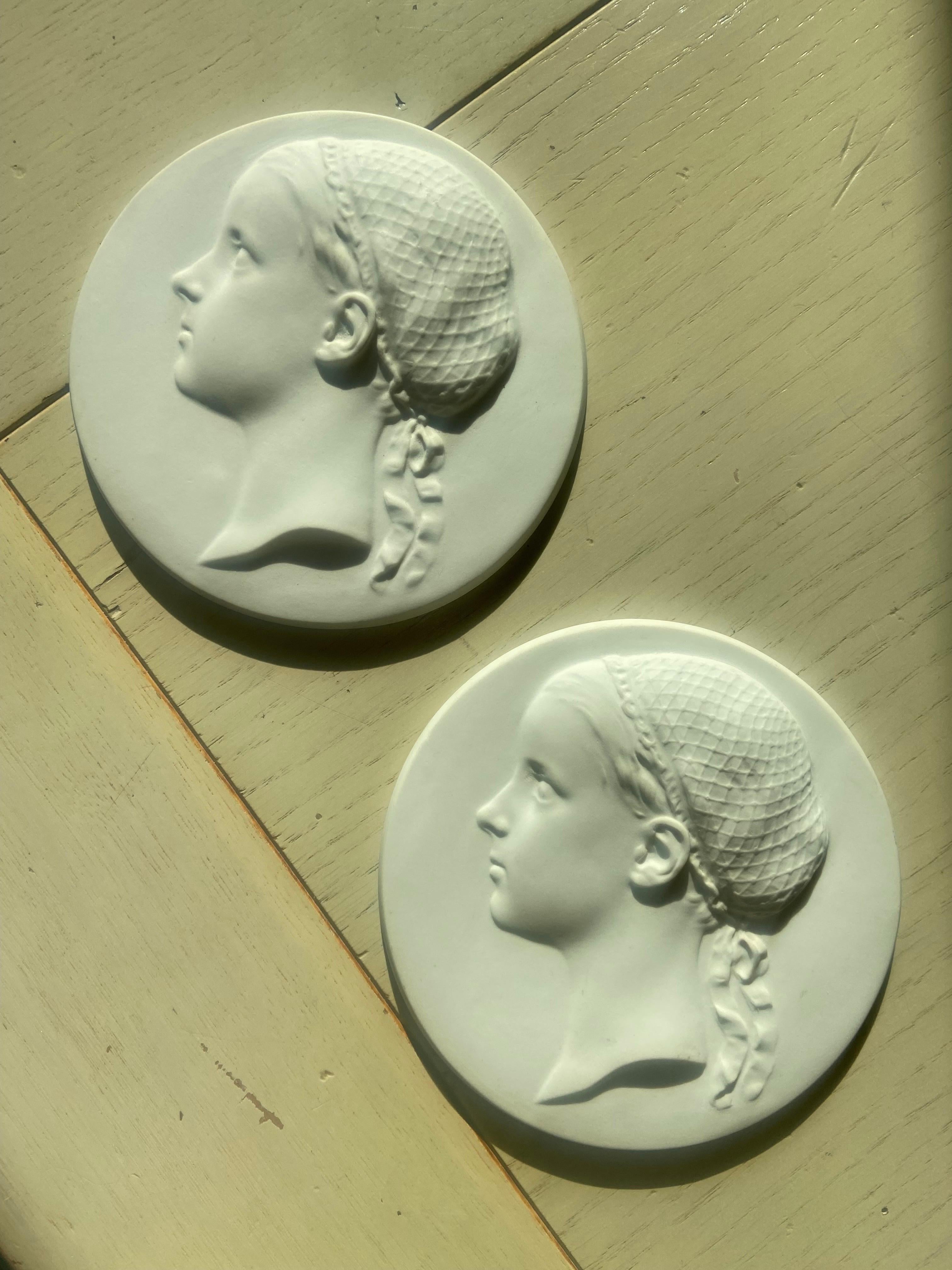 Two discs in fine white biscuit made by Sevres in France in the late 19th century. Both have identical form of a left profile of a young lady, her hair held up by a lace headdress. Diam. : 13cm. Very good condition with no restorations.
France,