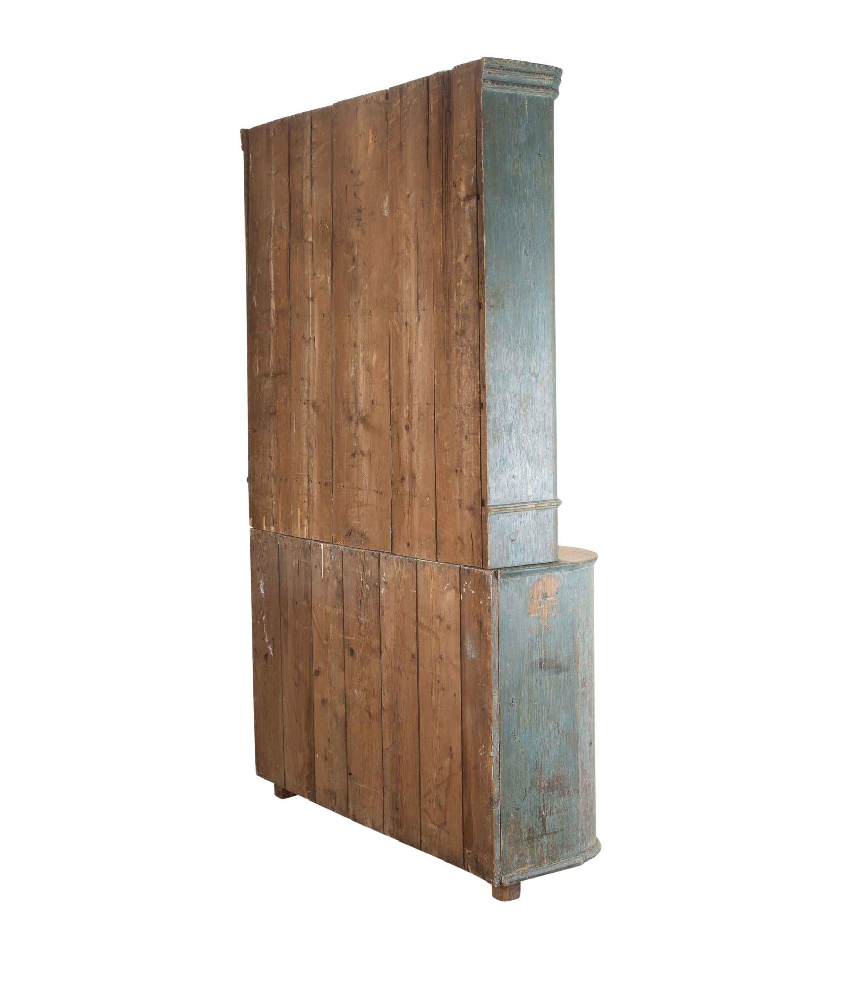 19th Century two part cabinet in original paint, from Umea Vasterbotten, Sweden.
The top section with decorative carving and panelled doors opening to useful storage shelves and drawers. The below section has decorative curved sides and panelled