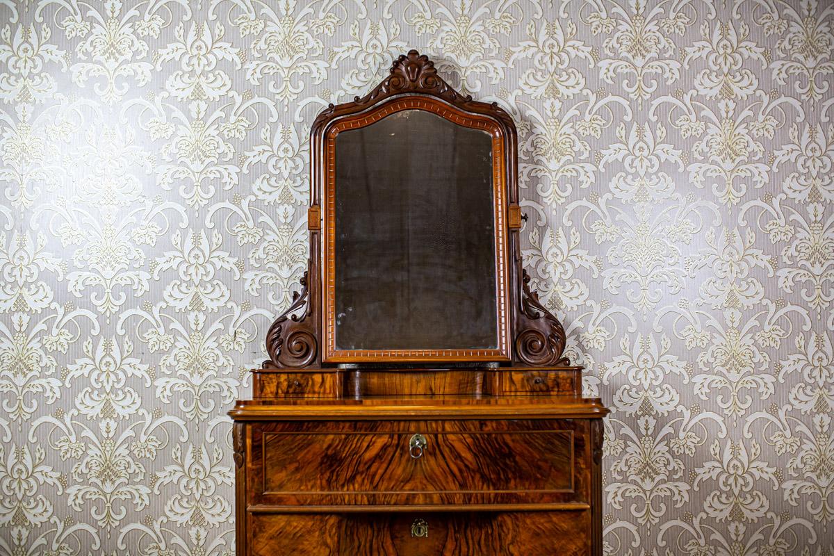 Zweiteilige Kommode mit Spiegel aus dem 19. Jahrhundert, braun furniert mit Palisanderholz

Wir stellen Ihnen dieses Möbelstück vor, das auf vielfältige Weise genutzt werden kann, zum Beispiel als Kommode, Sekretär oder Waschtisch.
Sie stammt aus
