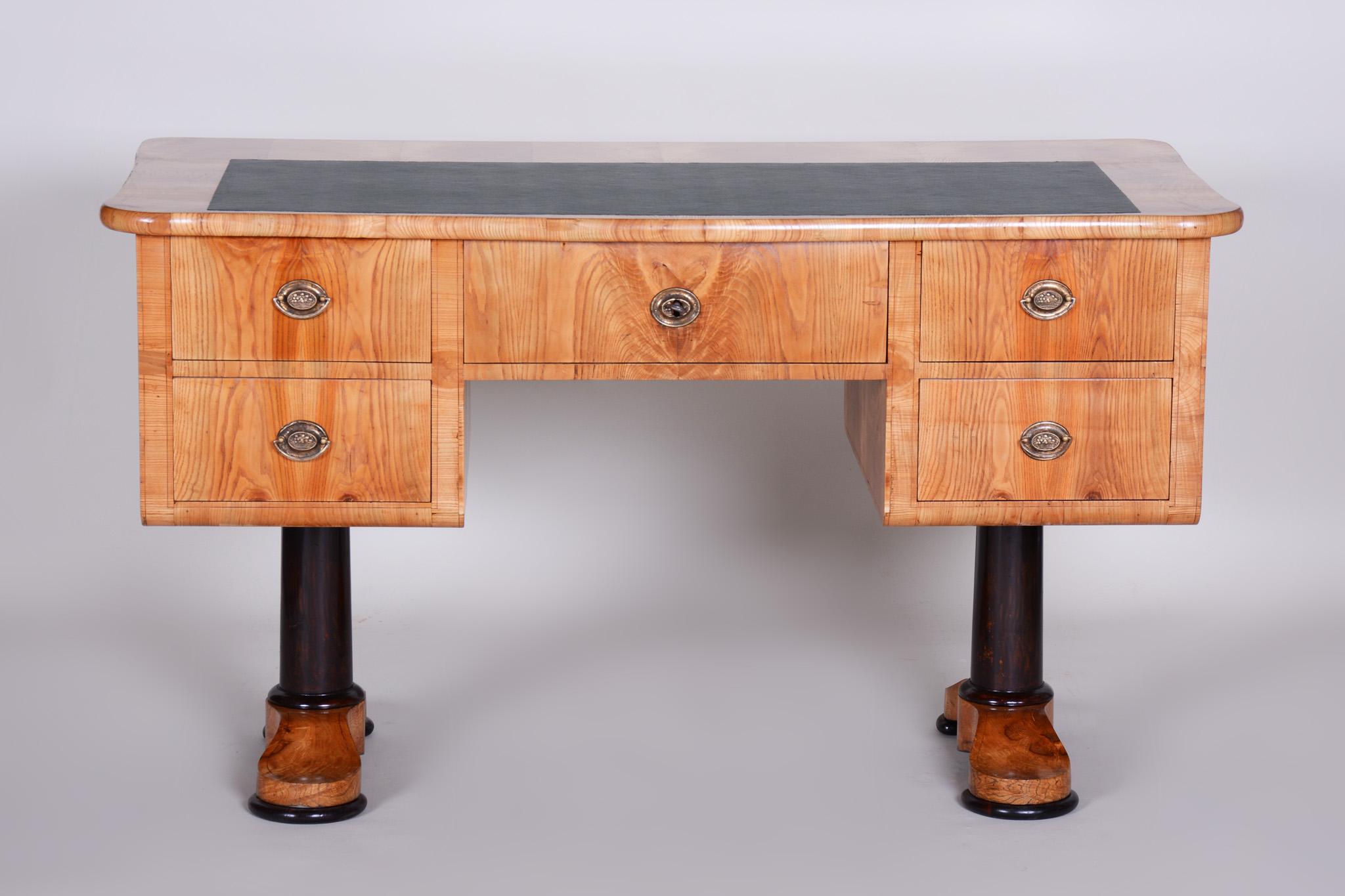 This elegant Biedermeier style writing desk originates from Bohemia from the first half of the 19th century. It is crafted from ash wood, which gives it a light and natural appearance with beautiful grain.

The desk has undergone careful