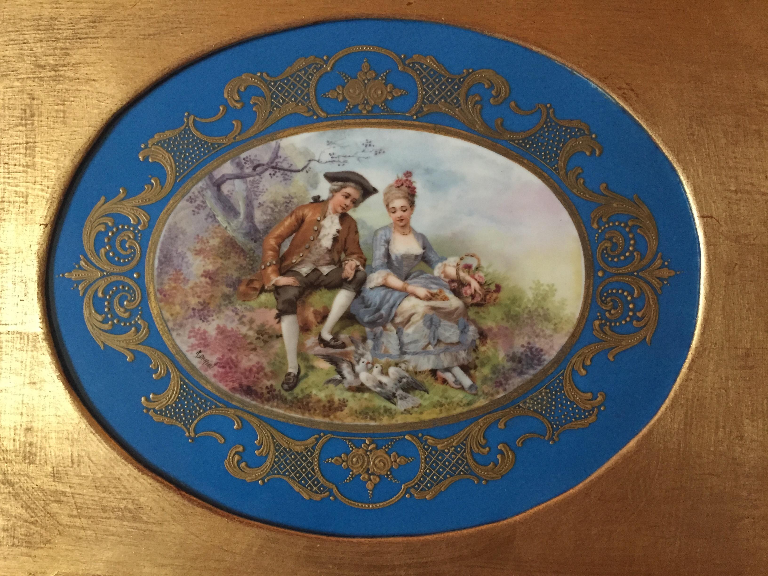 A circa 1880 masterpiece of a young couple feeding doves. This is a superb example of a 19th century unmarked Sèvres hand painted porcelain plaque. Signed by the artist R. Deniau. The motive depicts young lovers in 18th Century costumes feeding a