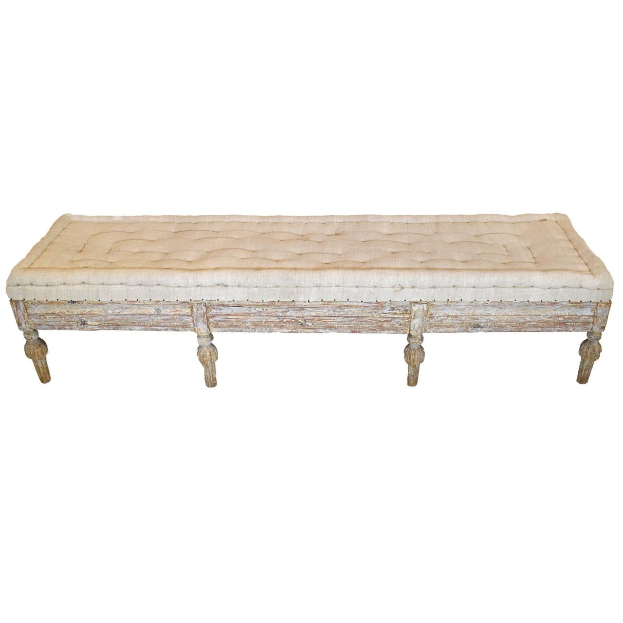 Extended length sets apart this classic Swedish bench. Carved on three sides upholstered in European burlap with tacks.