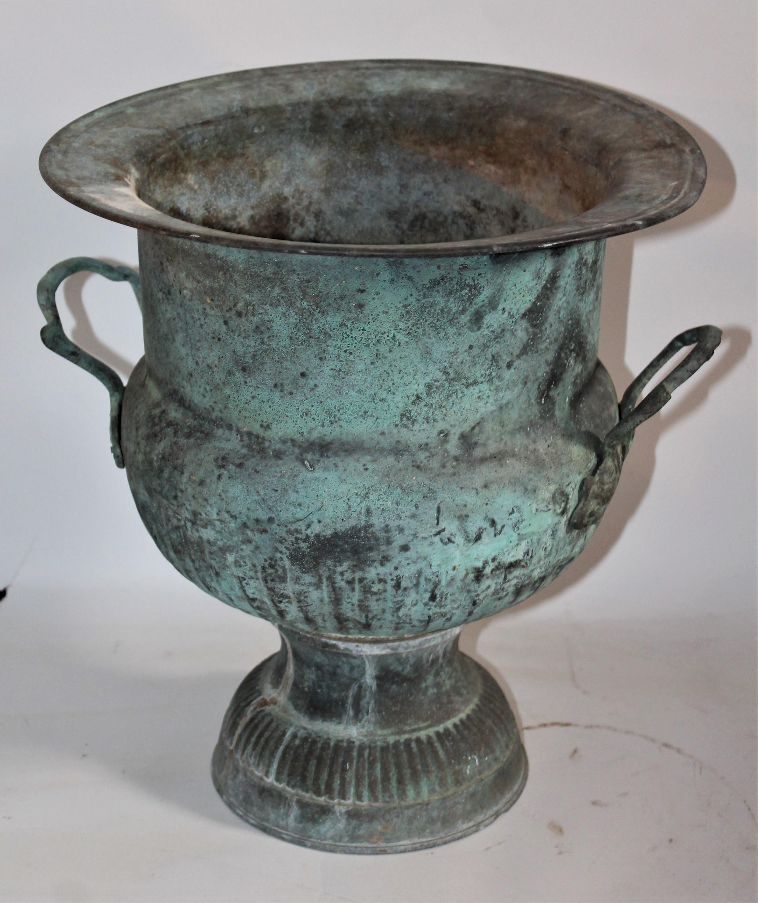 This copper urn has a amazing untouched copper patinated surface and double handles. The condition is very good.