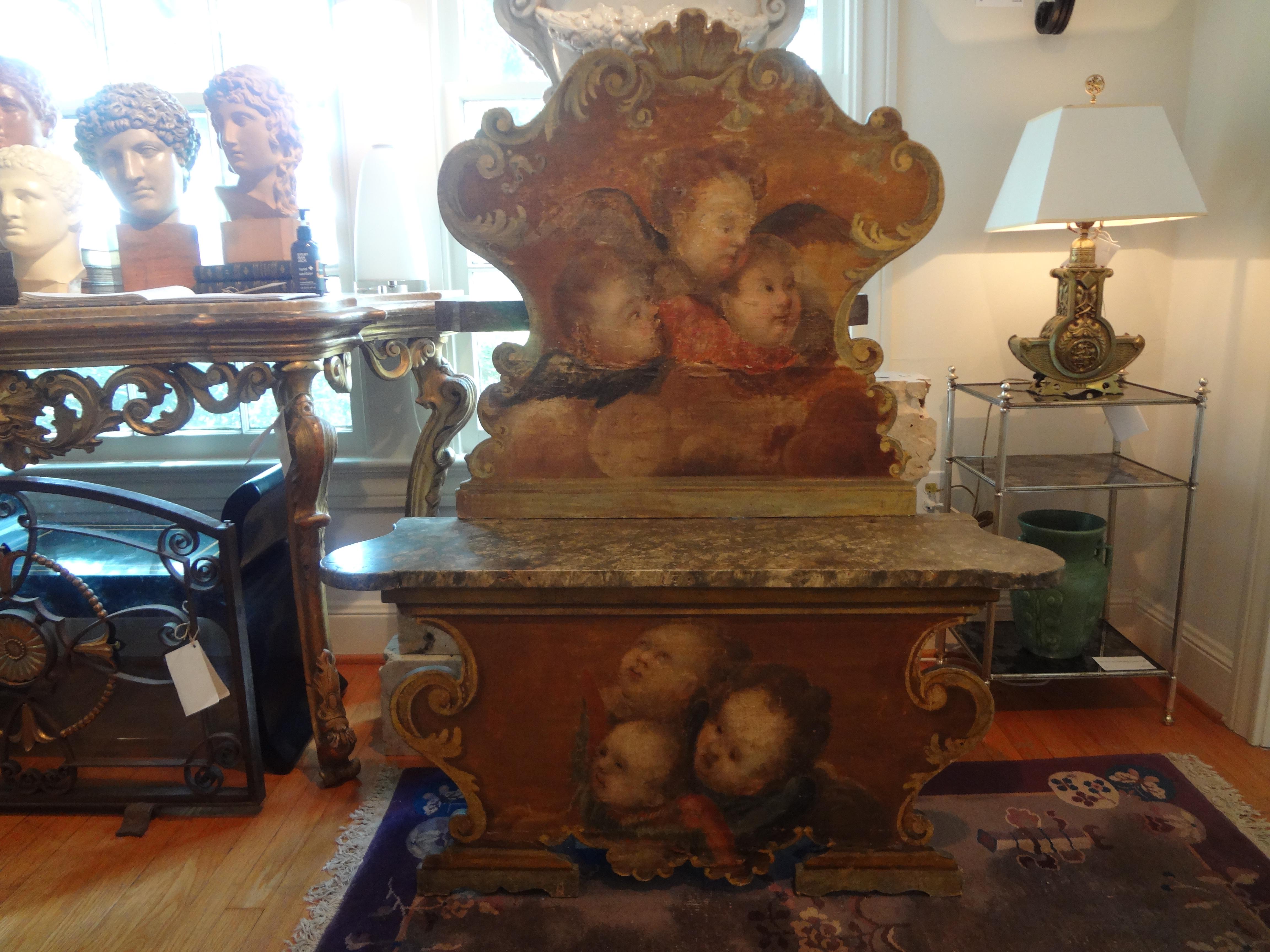 Stunning antique Venetian Baroque style carved and painted cassapanca or bench with a tall scrolled back and a scrolled lower frame. This lovely 19th century Venetian bench is painted with putti or angels on both the upper and lower portion. The