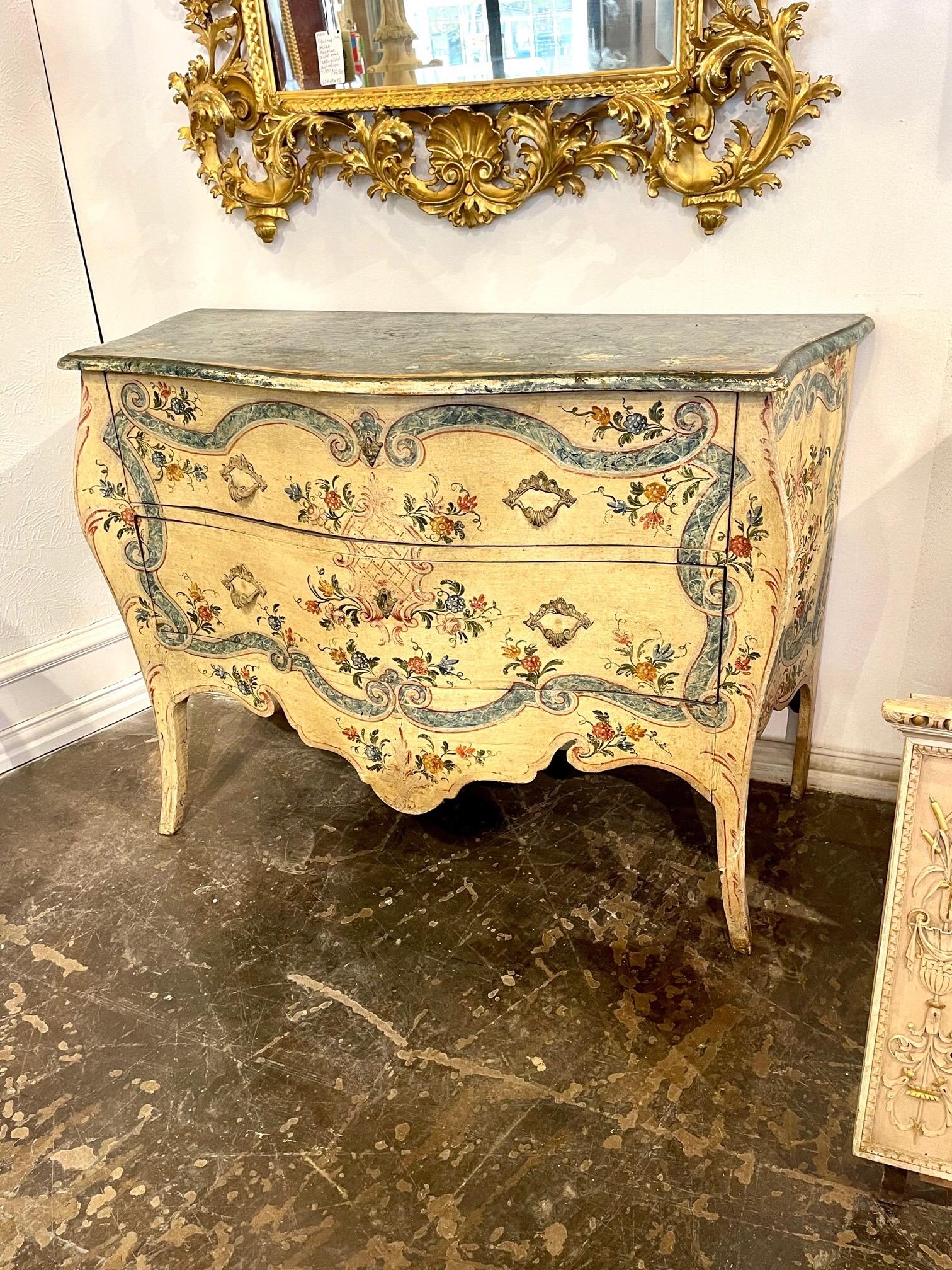 Lovely decorative 19th century Venetian hand painted bombe commode. Featuring beautiful floral images in the colors of blue, pink and gold. Great patina as well. So pretty!!