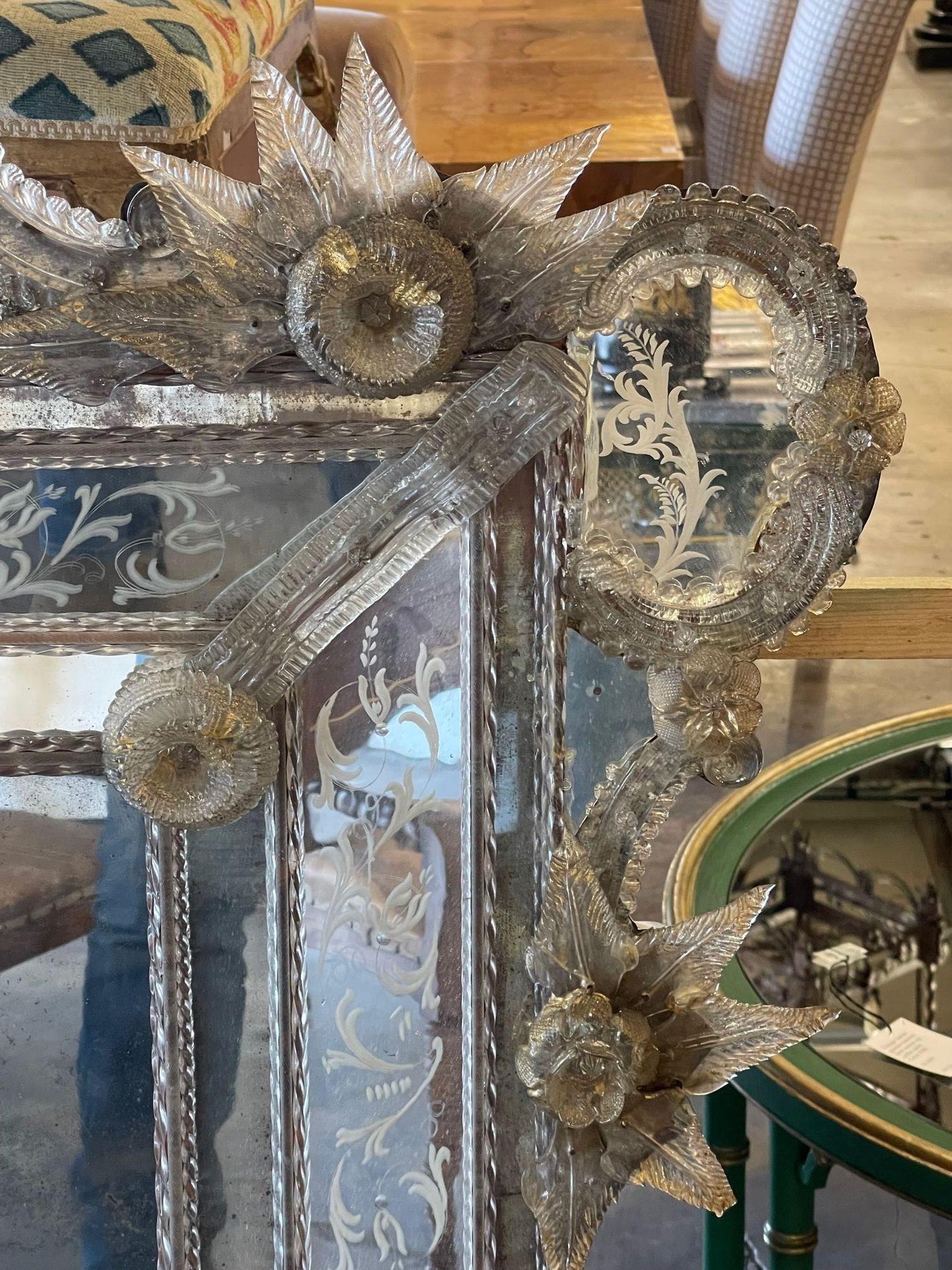 Exceptional 19th century Venetian etched glass mirror with leaves and flowers. Beautiful scrolling shape along with glistening glass in silver and gold. A real work of art that is sure to impress!! Gorgeous!.