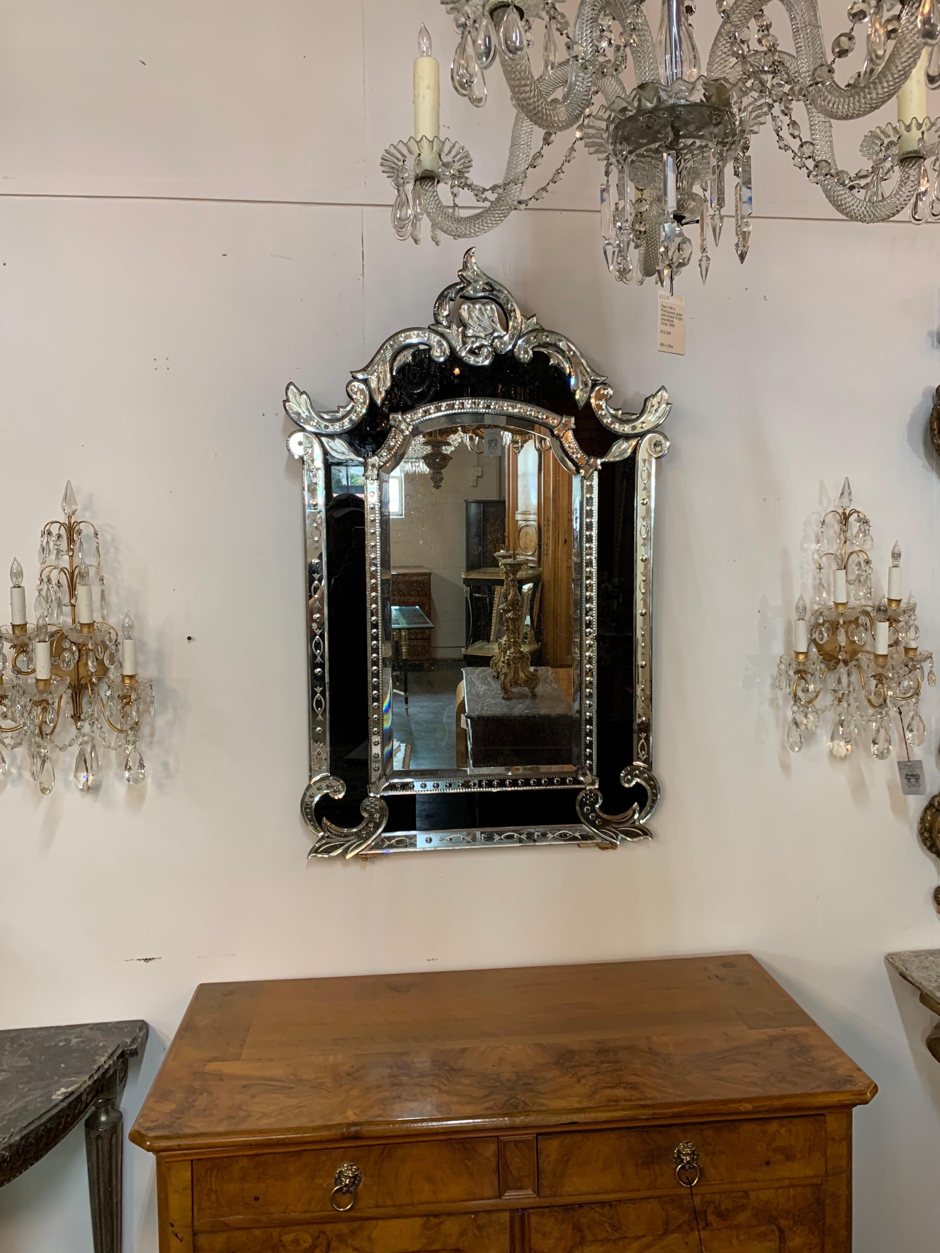 Very handsome 19th century Venetian etched mirror with black glass. Beautiful cut out shapes on the outer border of the mirror. And the black glass creates an interesting decorative impact! Stunning!