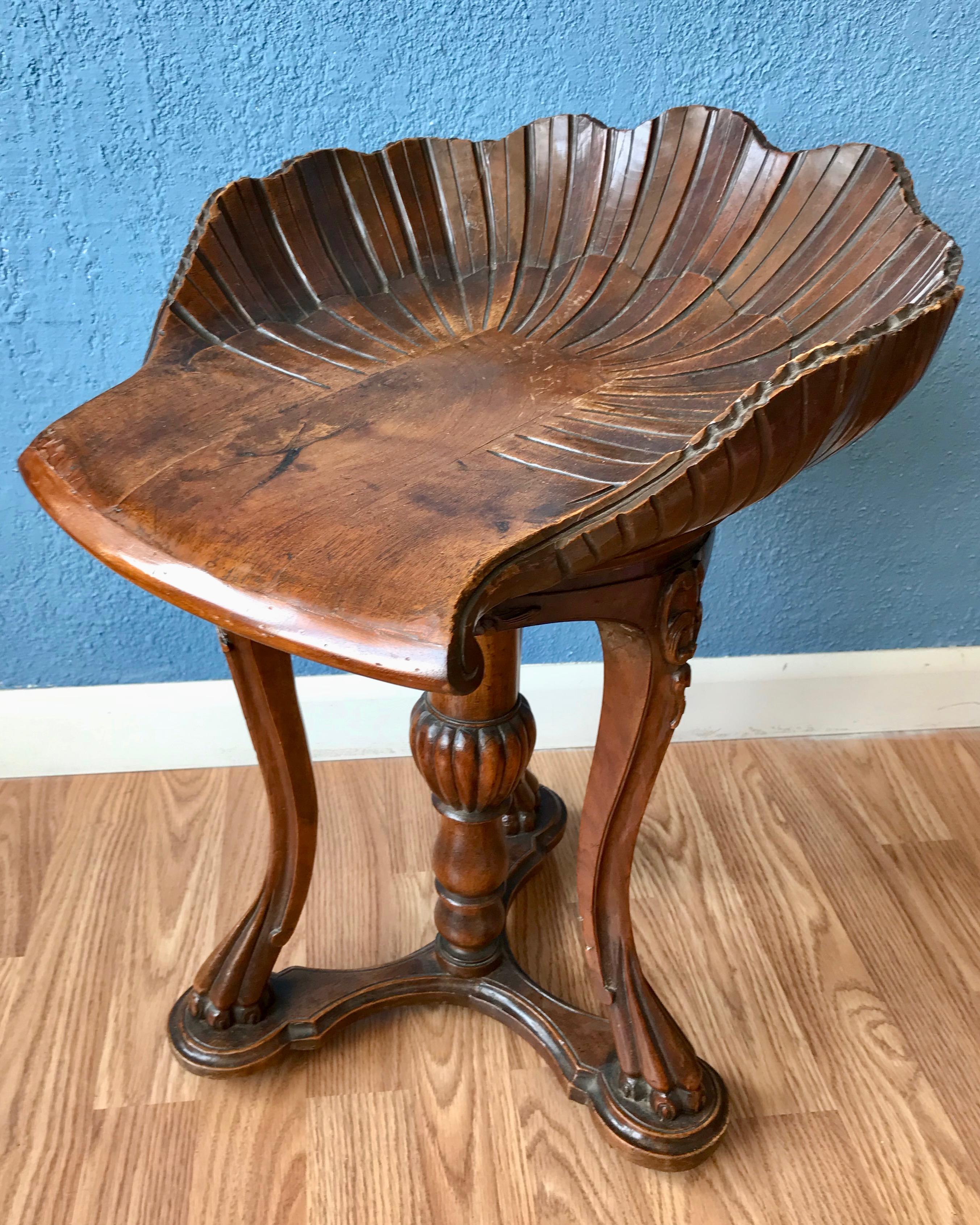 Fashioned with a shell form swivel seat. The stool is nicely carved with a mellow
fruitwood patina. Superb quality and details.