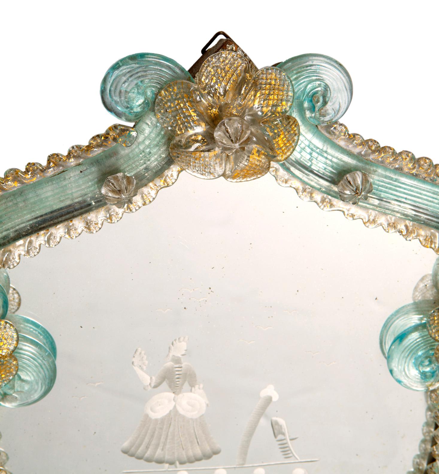 Venetian Etched & Blown Glass candle sconce. The mirrored glass back is etched with romantic costumed courtesan with trees & foliage.
There are gold flecks in the glass trimmed edge.
The hand blown glass frame is embellished with flowers & ruffles