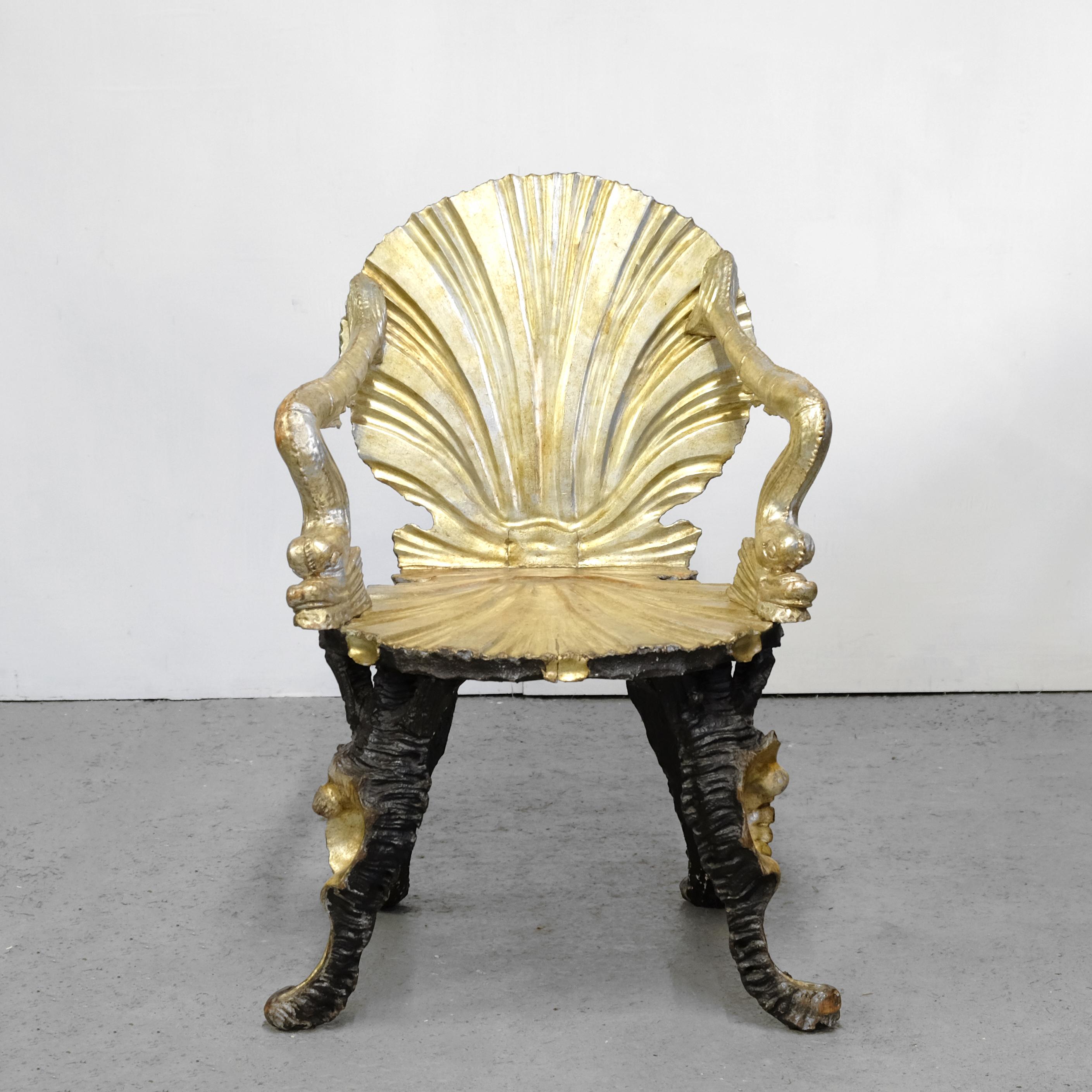 An exceedingly rare opportunity to own an original and exceptional Venetian grotto chair in original silver leaf and paint, attributed to Pauly et Cie. The back shaped to resemble an open scallop shell, the arms of dolphin form and the legs in the