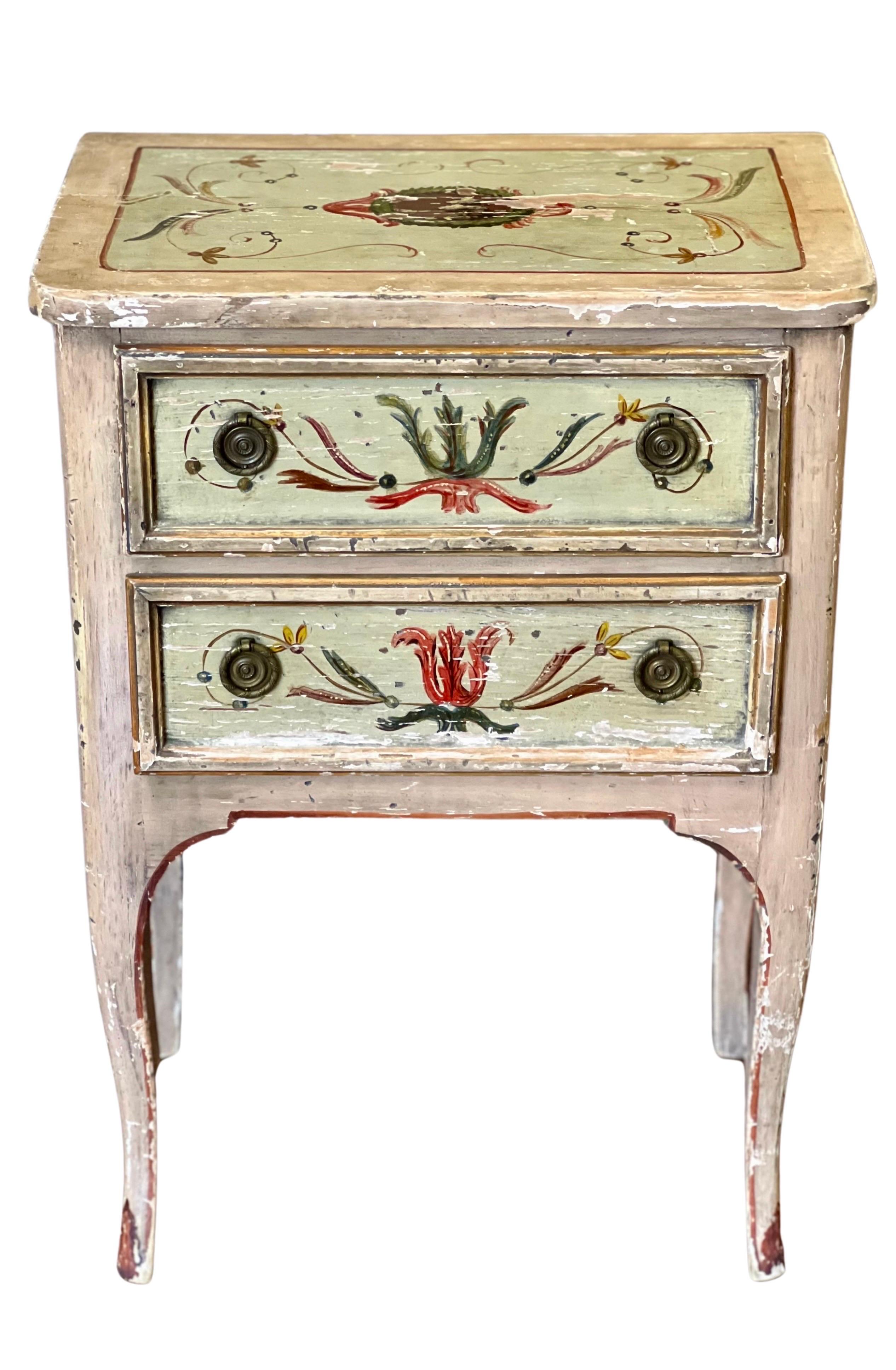 Antique Italian Neoclassical style small commode or stand, c. 19th century.

Gorgeous petite chest with a cheerful and vivid, hand-painted Venetian design of scrolling foliate motifs. The base colors of cream and pale green have accents in shades of