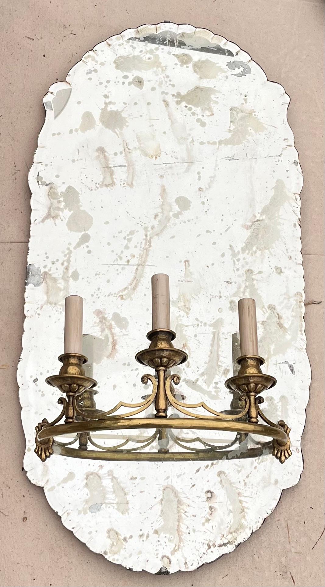 Pair of large scale antique mirror glass Italian sconces with three arms. They retain their original wood backs and are electrified. They make a fantastic presence in any installation.