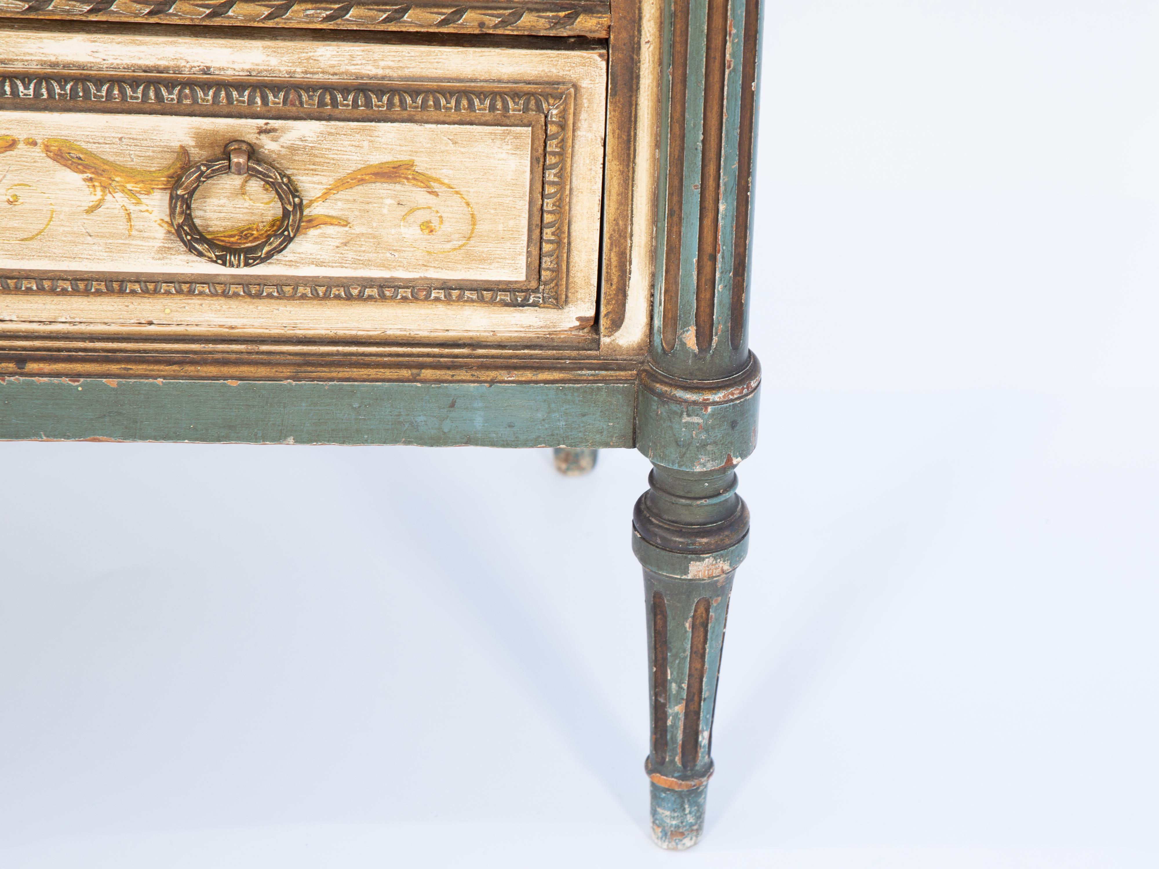 Venetian-painted hall chest or bedside table, having a rectangular mirrored top, on handpainted base of four raised and fielded stacked drawers, handpainted with scrollwork, florals, and cherubs, mounted with ring pulls, flanked by round, fluted
