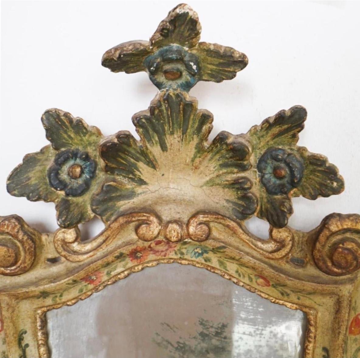 A 19th century Venetian carved wood and paint decorated mirror. Decorated with floral sprays and carved gilt wood accents. Solid sturdy mirror ready to be used to add an old world charm to any room.