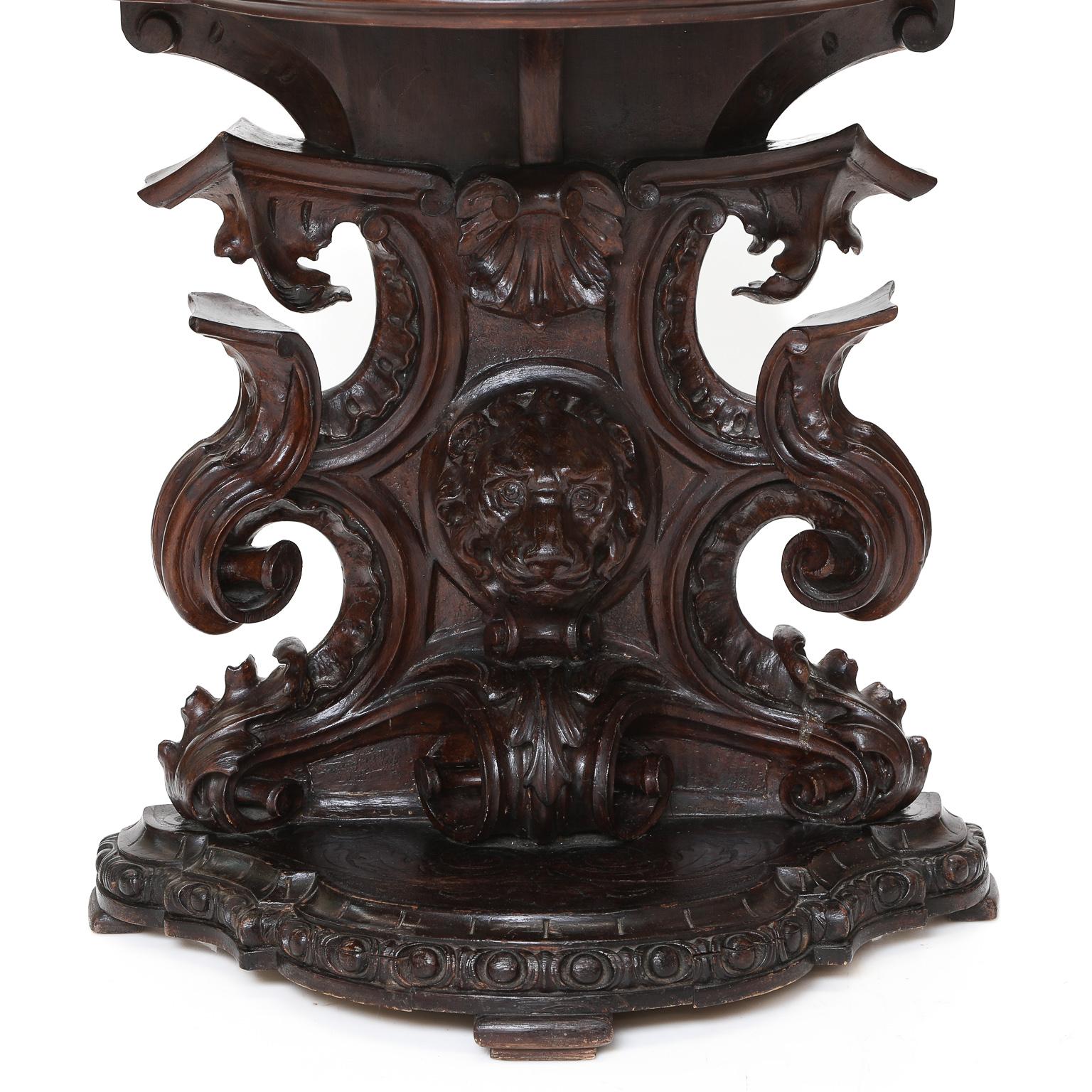 19th century Venetian Walnut Console Table, Having Shaped Top with Vert Tinos Marble Insert, Carved Apron, and Elaborate Base Focused with Lion Face Mask Flanked by Heavy Scrolls, Gadroon Leaves, Acanthus Leaves, Leading to Platform Base. Shape