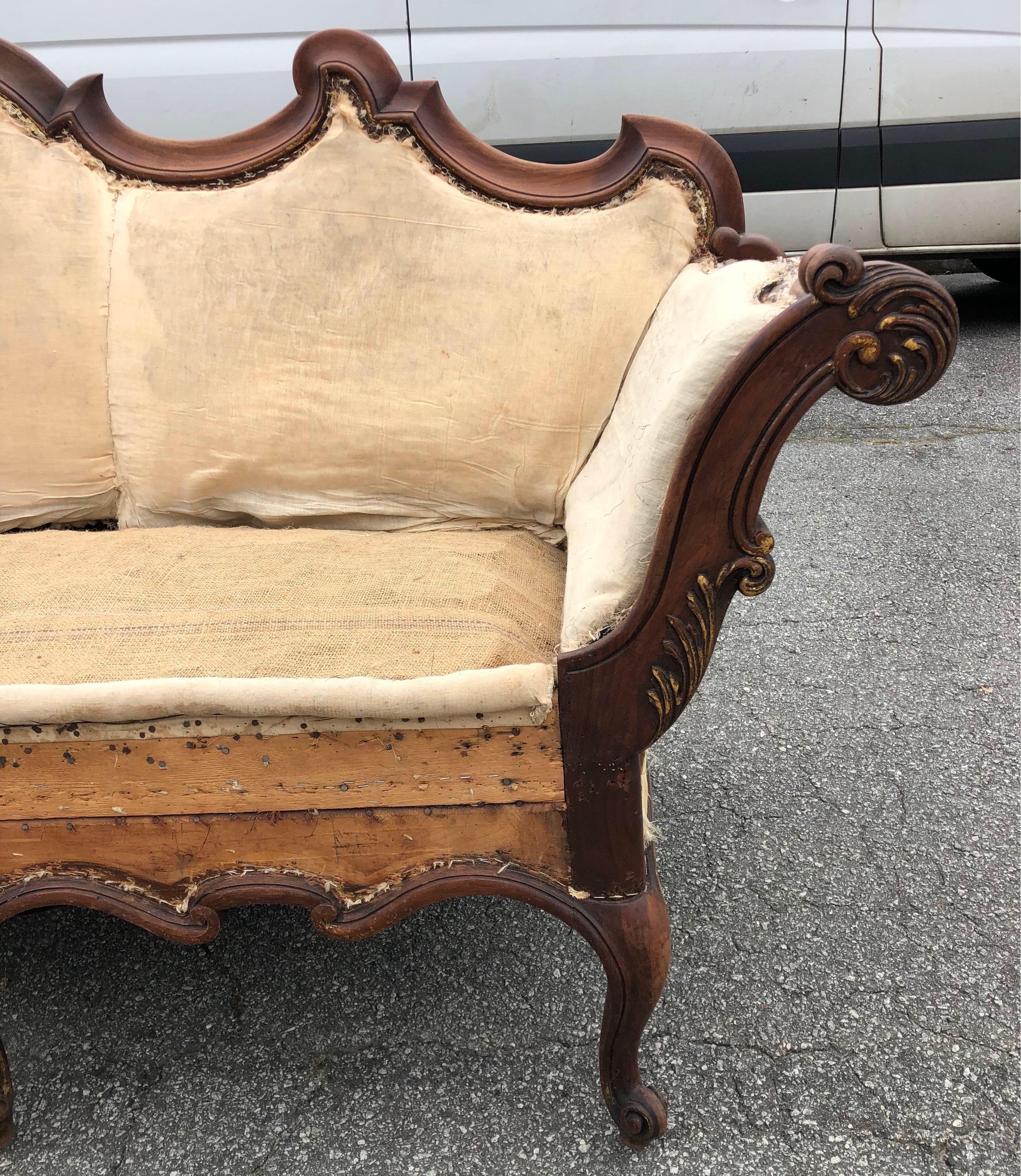 Beautiful 19th century Venetian walnut sofa dressed in original muslin and burlap ready for your choice of upholstery fabric. Carved walnut frame has traces of original parcel gilding on arms and around bottom rails.
  