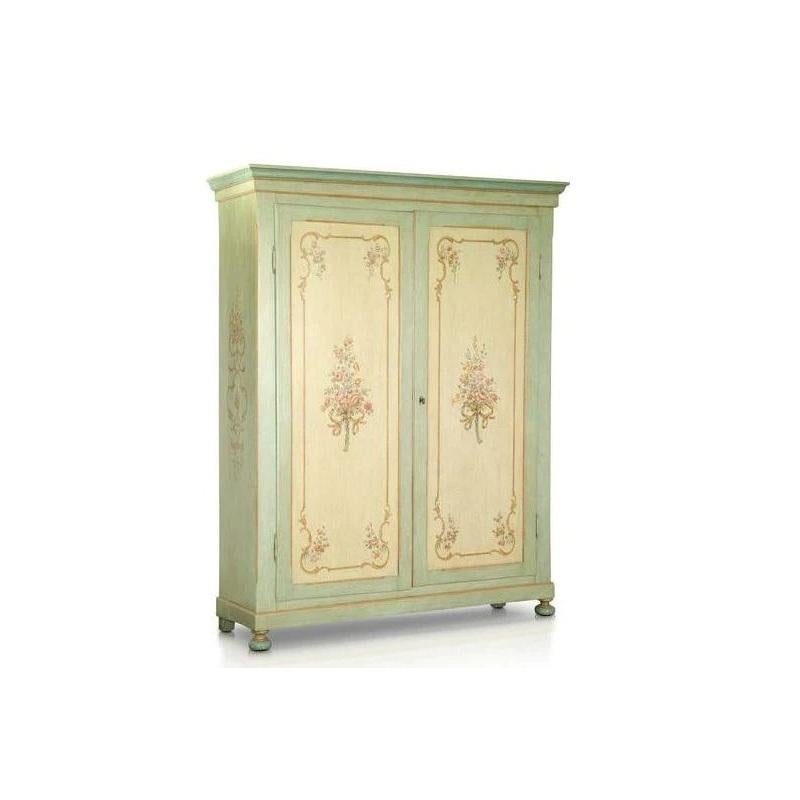 This sensational 19th century Venetian Armoire features delicate fiore bouquets hand- painted on the front door panels, accompanied with fiore scroll work on the front and sides. A lovely aged blue patina frames the beautiful hand-painting and the
