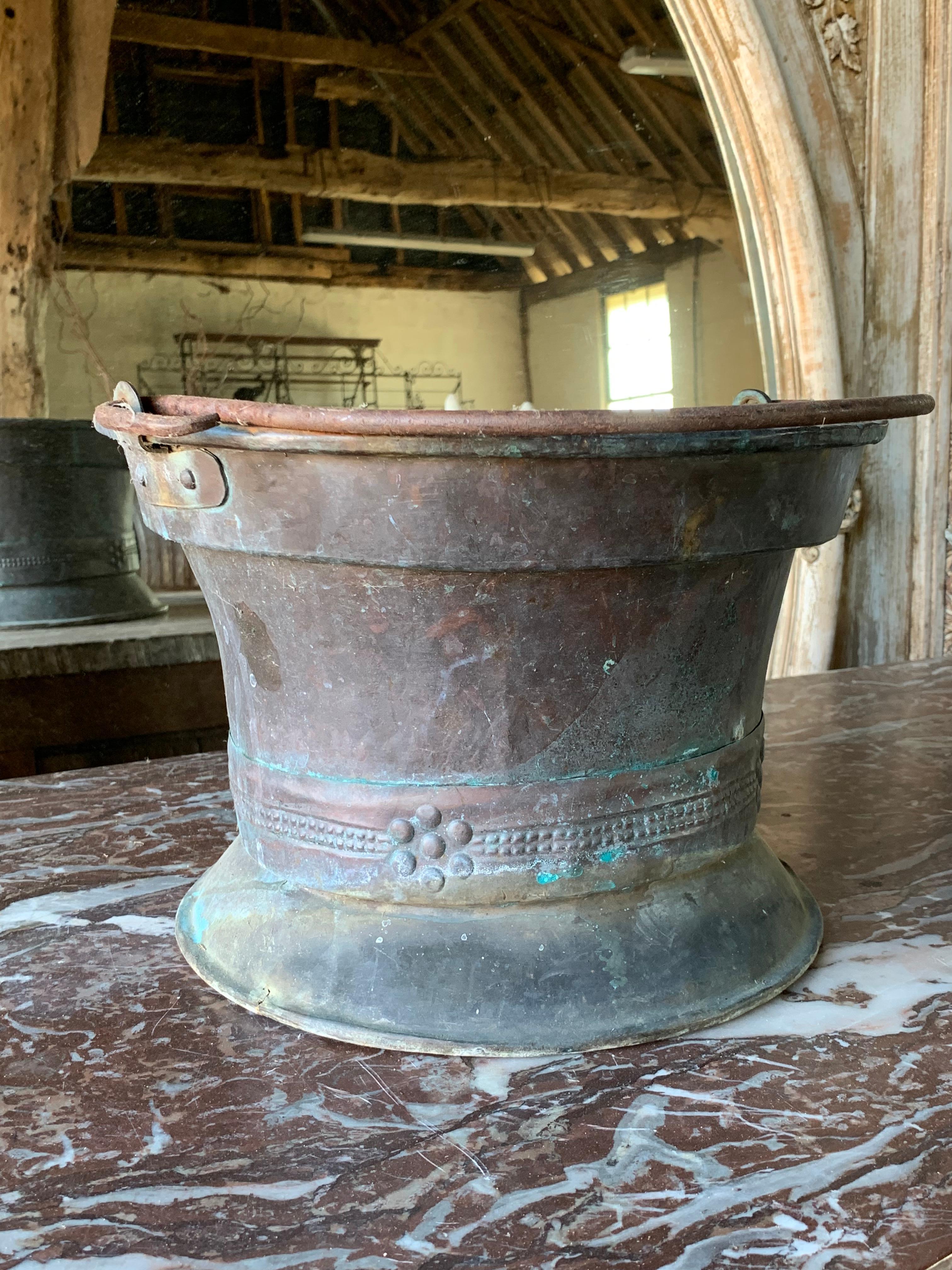 A nice late 19th century copper planter with original iron carrying handle. The copper has a nice verdigris colour giving it a nice decorative look. 23cm high to the rim.

Please contact us directly for a worldwide shipping quote 