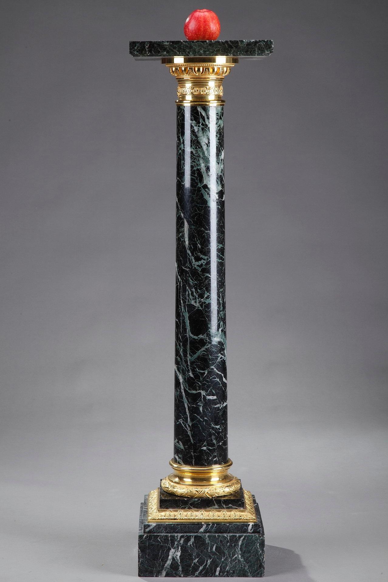 Green Vert-de-Mer marble pedestal with ormolu bronze cap and base. The capital is embellished with gadroon, pearls and floral motif, and the base is decorated with laurel and ribbon. This display column is set on a square, terraced base, highlighted