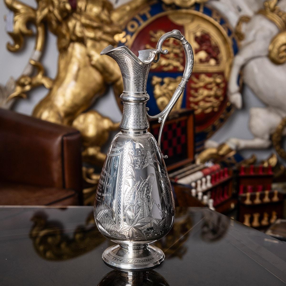 Antique 19th century Victorian Aesthetic movement solid silver wine jug, the bulbous body beautifully hand engraved with chinoiserie scenes of nobility in traditional silk dress and a merchant carrying goods suspended over the shoulder, surrounded