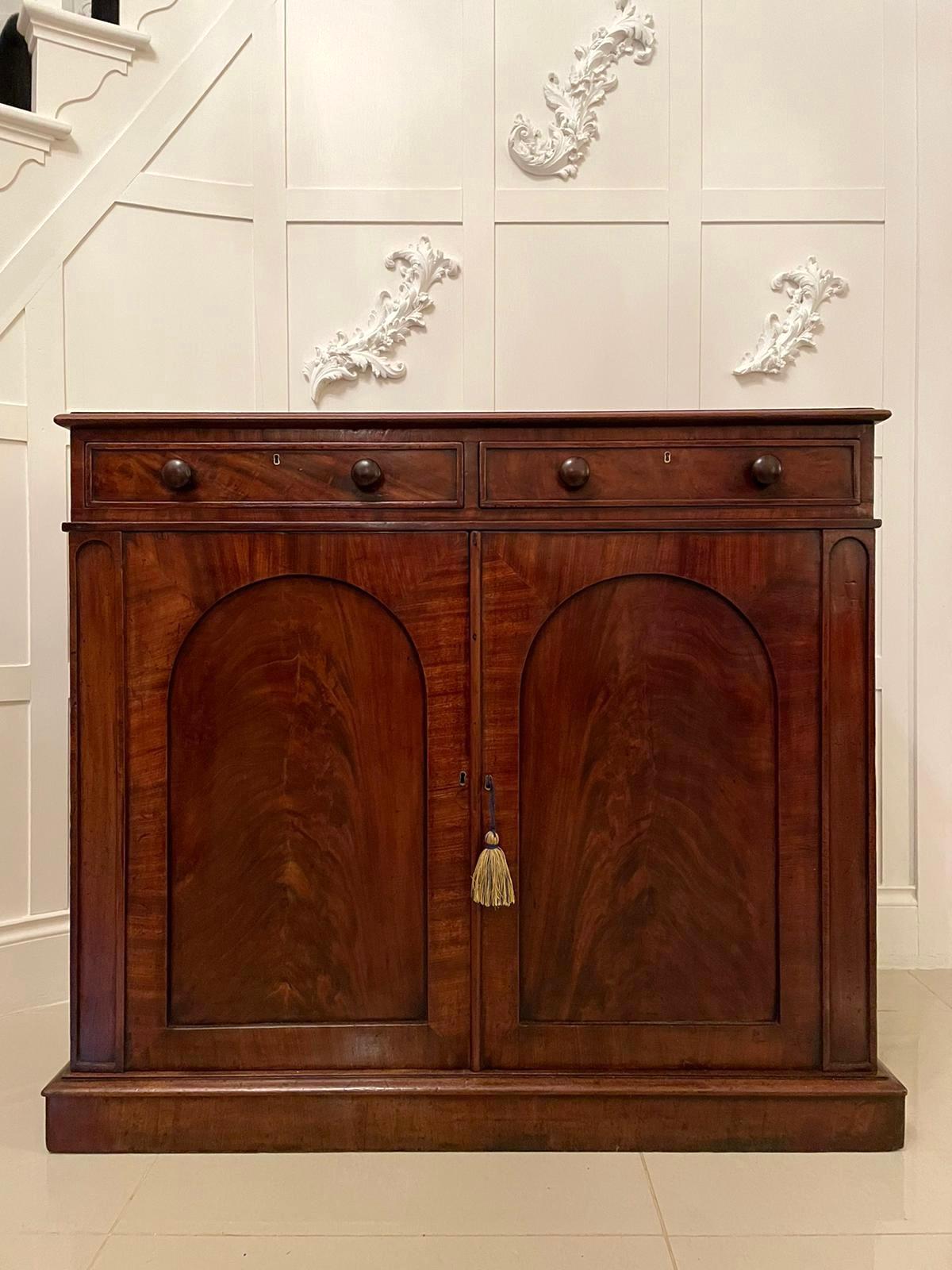 19th century Victorian antique mahogany side cabinet having a very attractive mahogany top with a moulded edge, two figured mahogany drawers with the original mahogany turned knobs, two figured mahogany doors with pretty arched panels which open