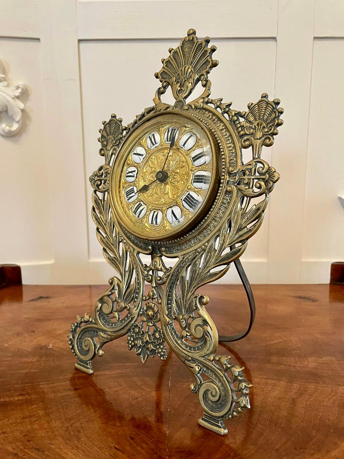 19th century Victorian antique ornate brass desk clock having an exquisite ornate brass and enamel dial with original hands, eight day French movement in a very pretty ornate brass case with scrolls, leaves and flowers. Original swing out support in