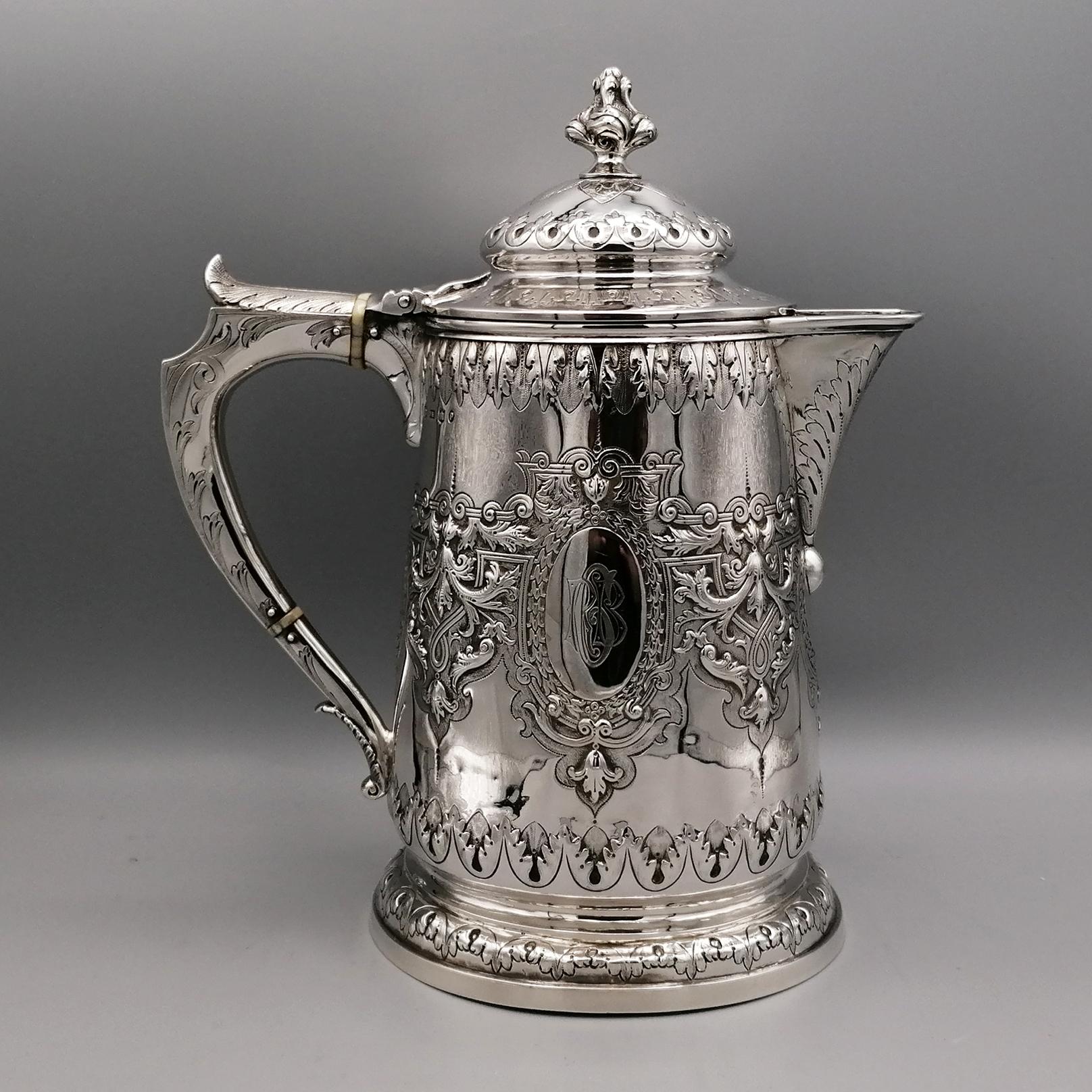 This magnificent antique Victorian English sterling silver pitcher has a simple conical shape on a widened circular foot.
The body of the jug is embellished with a magnificent engraved foliate decoration, incorporating two large cartouches.
The