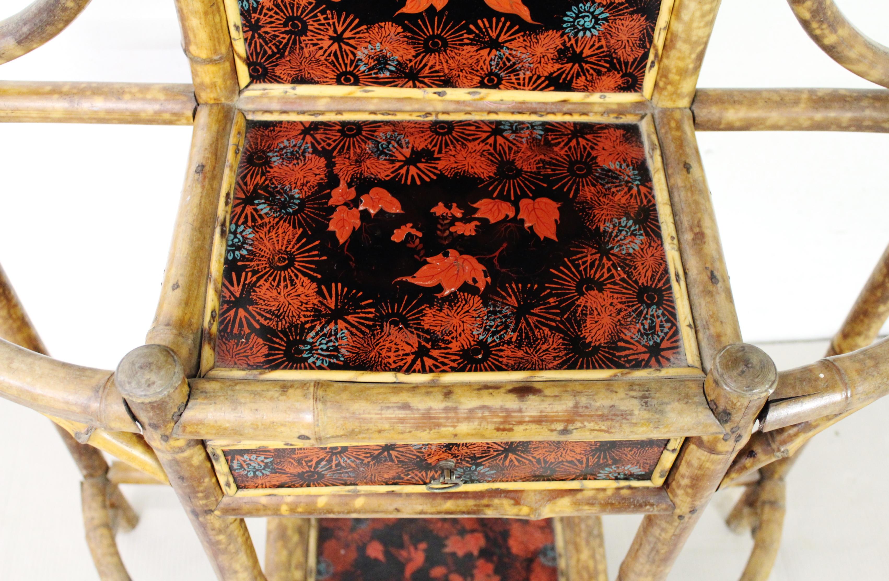 A lovely decorative late Victorian period bamboo hall stand. Of ornate style and appearance. Decorated with lacquered panels which are in very good order. With hooks for hanging coats (or hats) a small central drawer (useful for keys) and a mirror ,