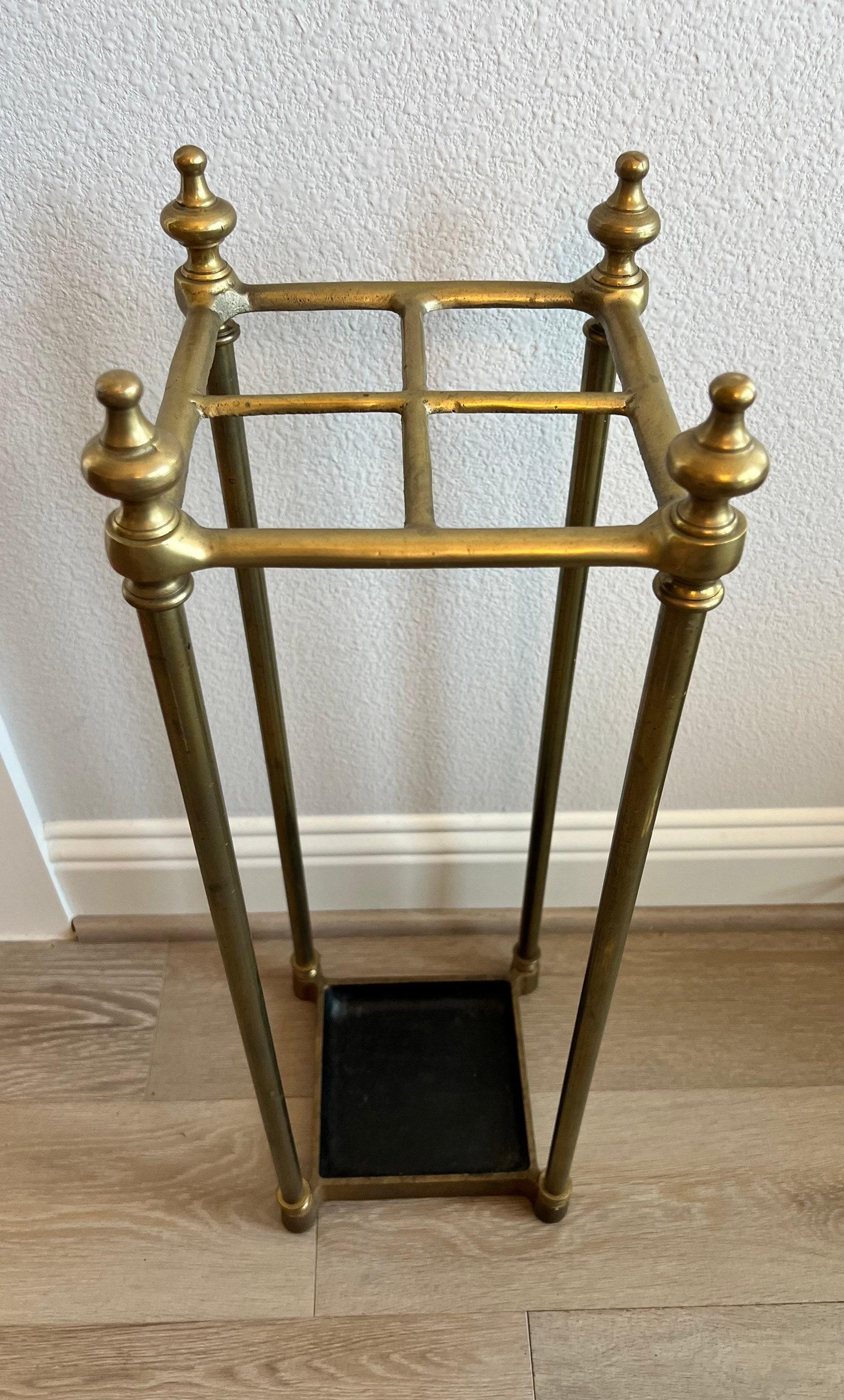 A fine mid-19th century Victorian umbrella stand with a brass top divided into four sections to hold either walking sticks, canes or umbrellas. circa 1860s.

The nicely patinated brass tubular four post frame comes together to form a square shaped