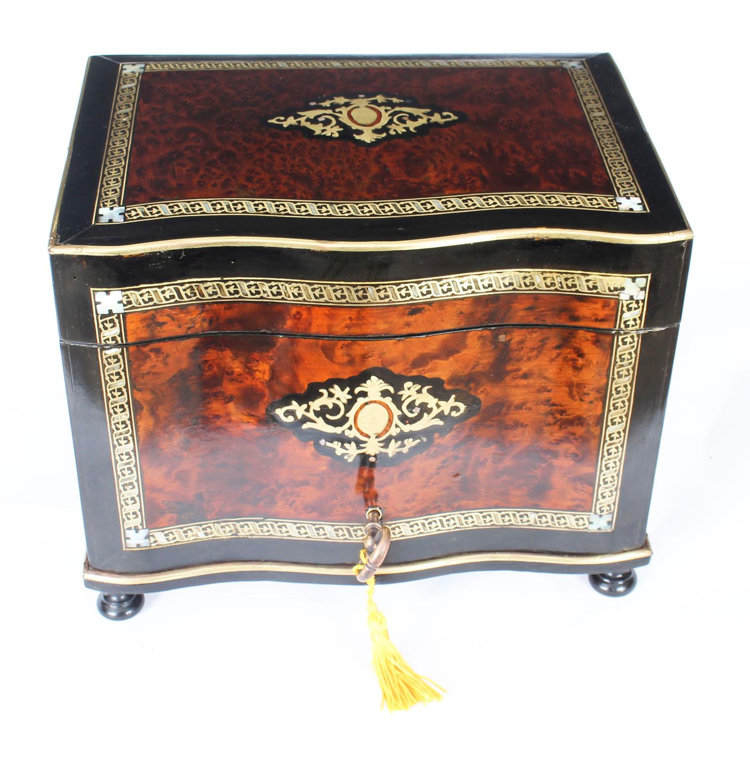 This is a magnificent antique Victorian burr walnut and boulle serpentine humidor, circa 1870 in date.
This splendid humidor is inlaid with exquisite bands of boulle cut brass strapwork, gilt cartouches and elegant mother of pearl motifs.

The