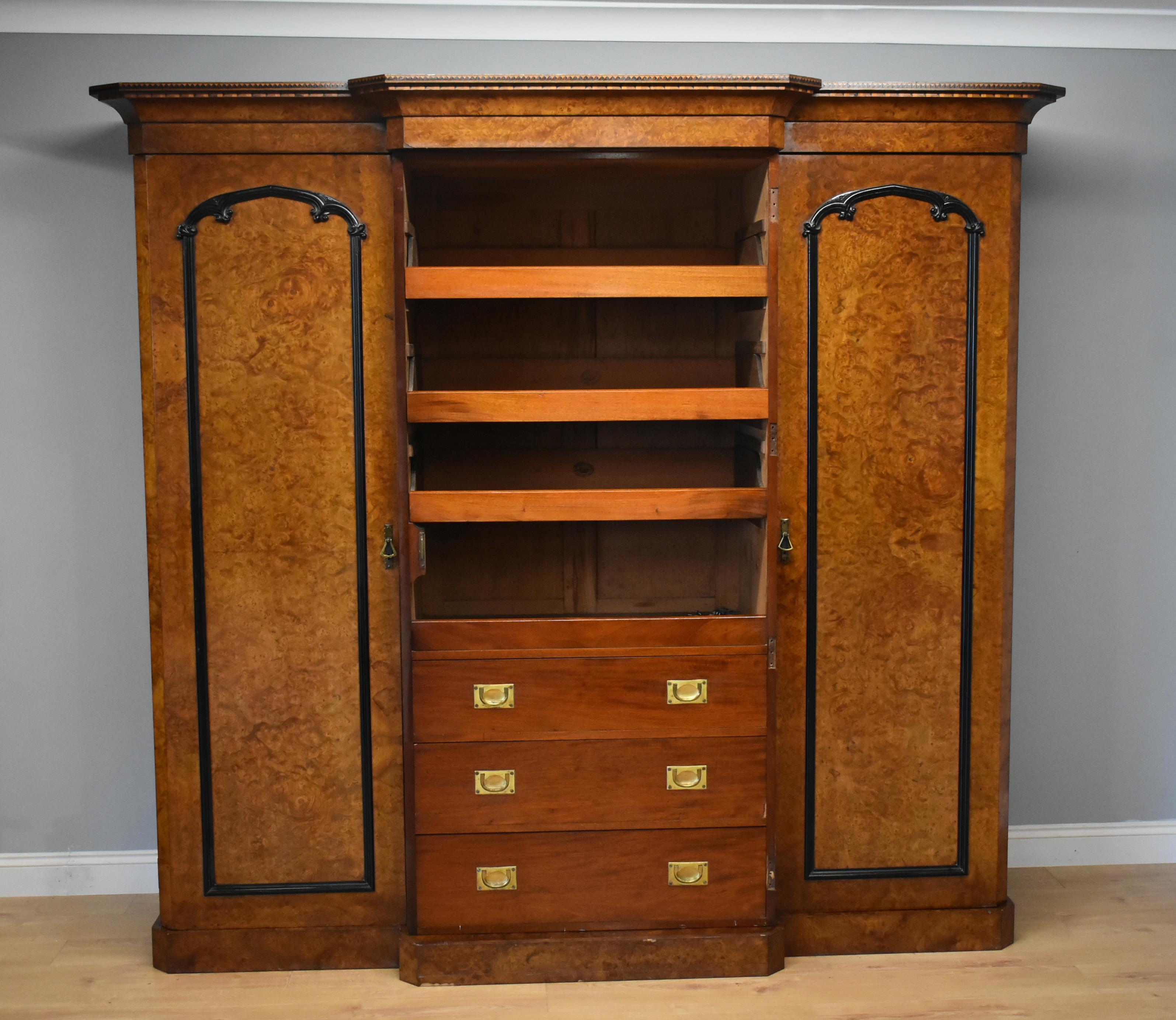 For sale is a good quality Victorian burr walnut breakfront wardrobe by R. Crosby & Sons of Liverpool, Established in 1827. The wardrobe has a stepped cornice above three doors, the centre of which having a full length mirror, opening to reveal a