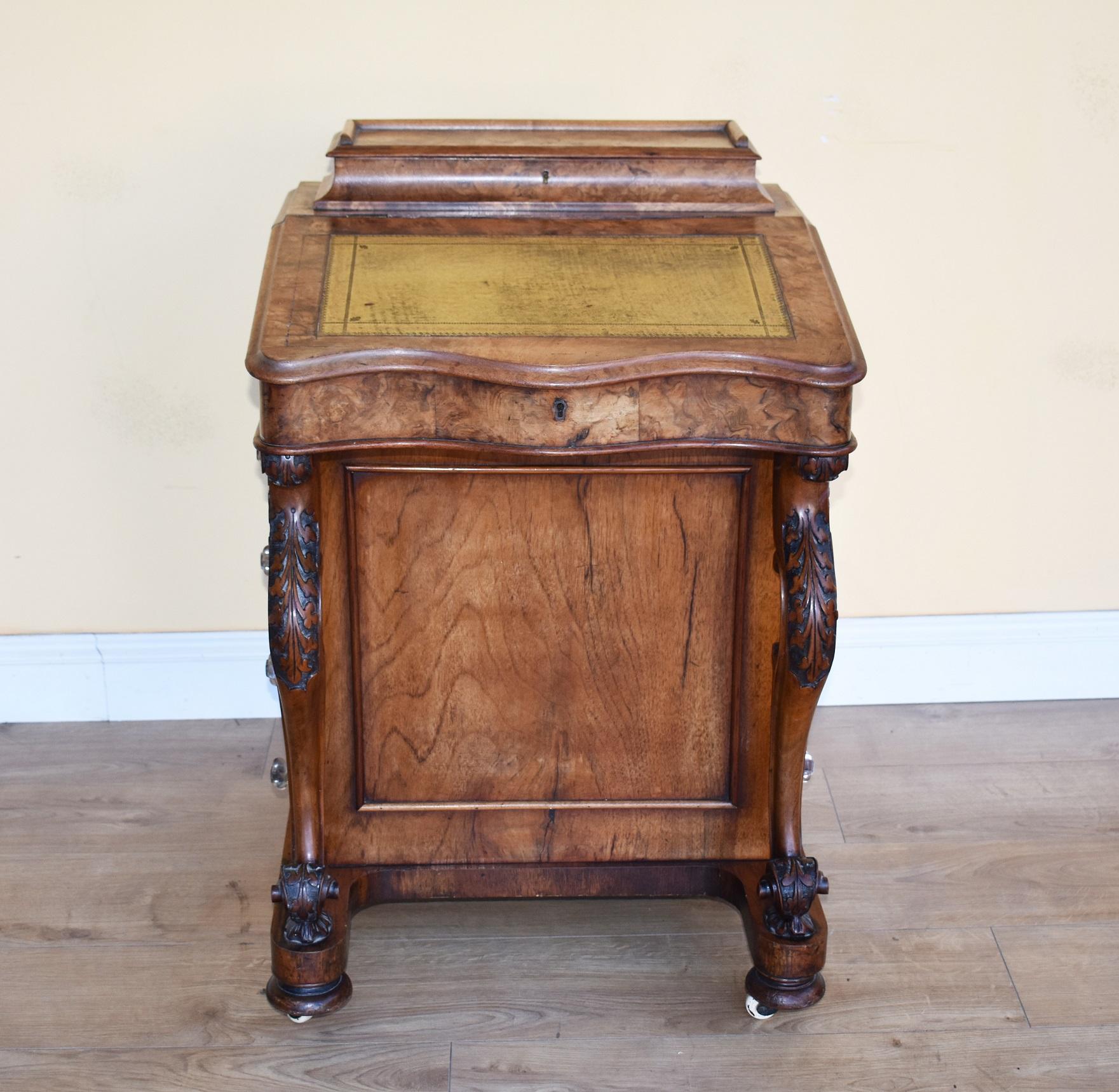 For sale is a good quality 19th century Victorian burr walnut davenport. The davenport is serpentine in form, having a shaped leather skiver writing surface, lifting to reveal a veneered interior with storage space. Below this, one side is fitted