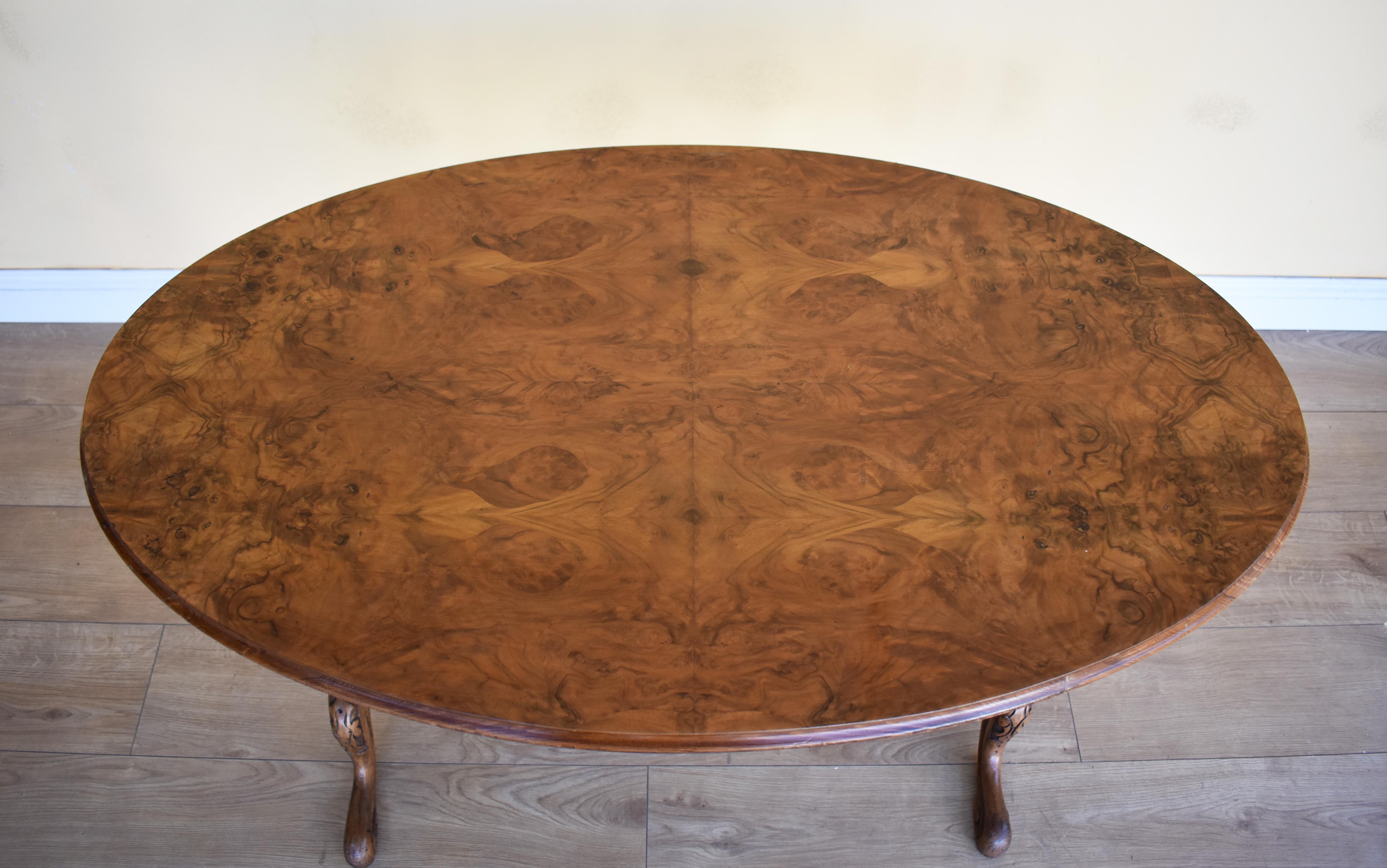 For sale is a fine quality 19th century Victorian burr walnut occasional table. The oval top, supported by two turned and carved columns, united by a stretcher, raised on elegantly carved feet. The table is in very good condition for its age.