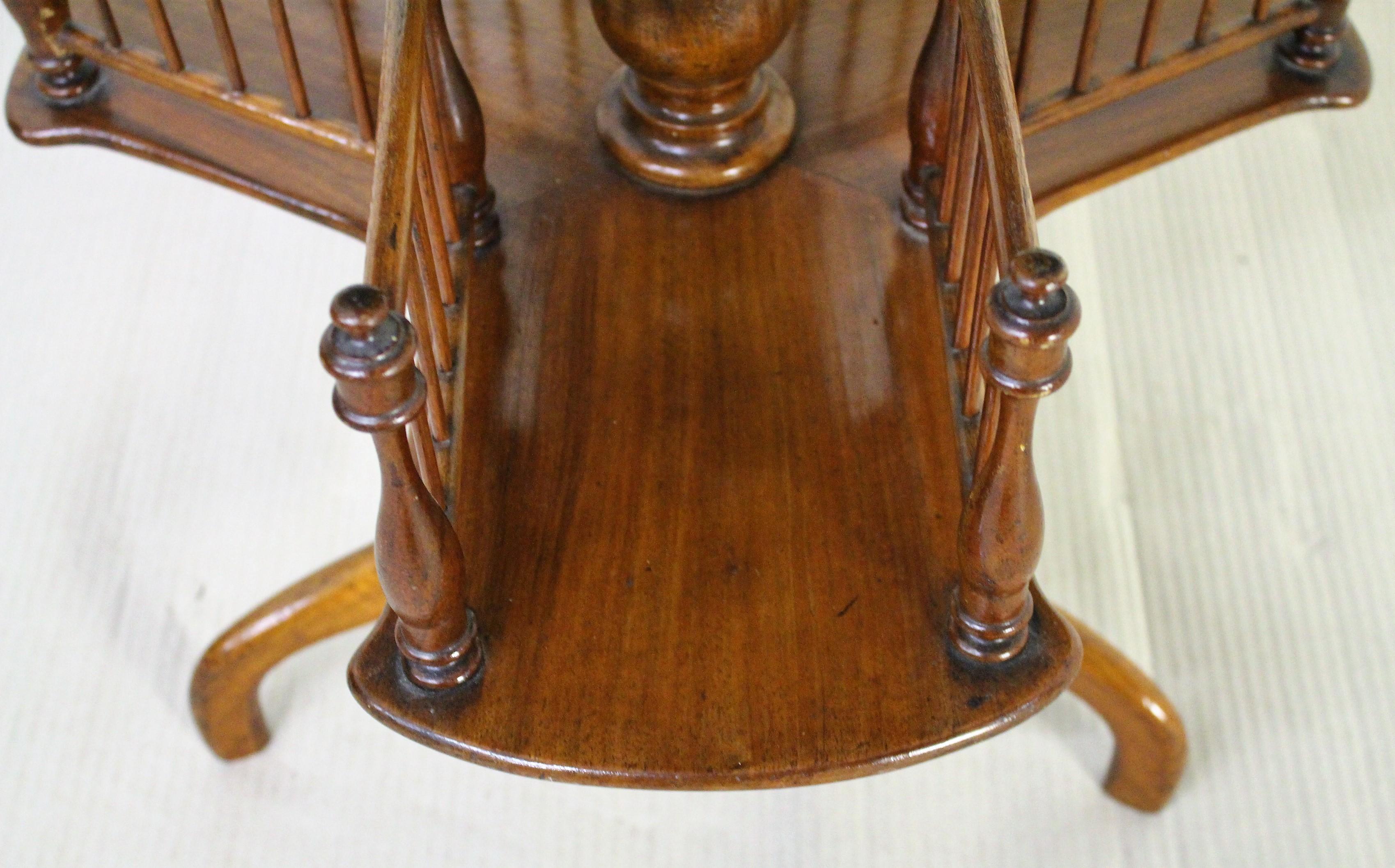 A lovely mid-Victorian period burr walnut revolving book table. The round top in burr walnut and the rest of the table in solid walnut. This table has two tiers for books (as opposed to the more typical one tier). The tiers revolve freely around the