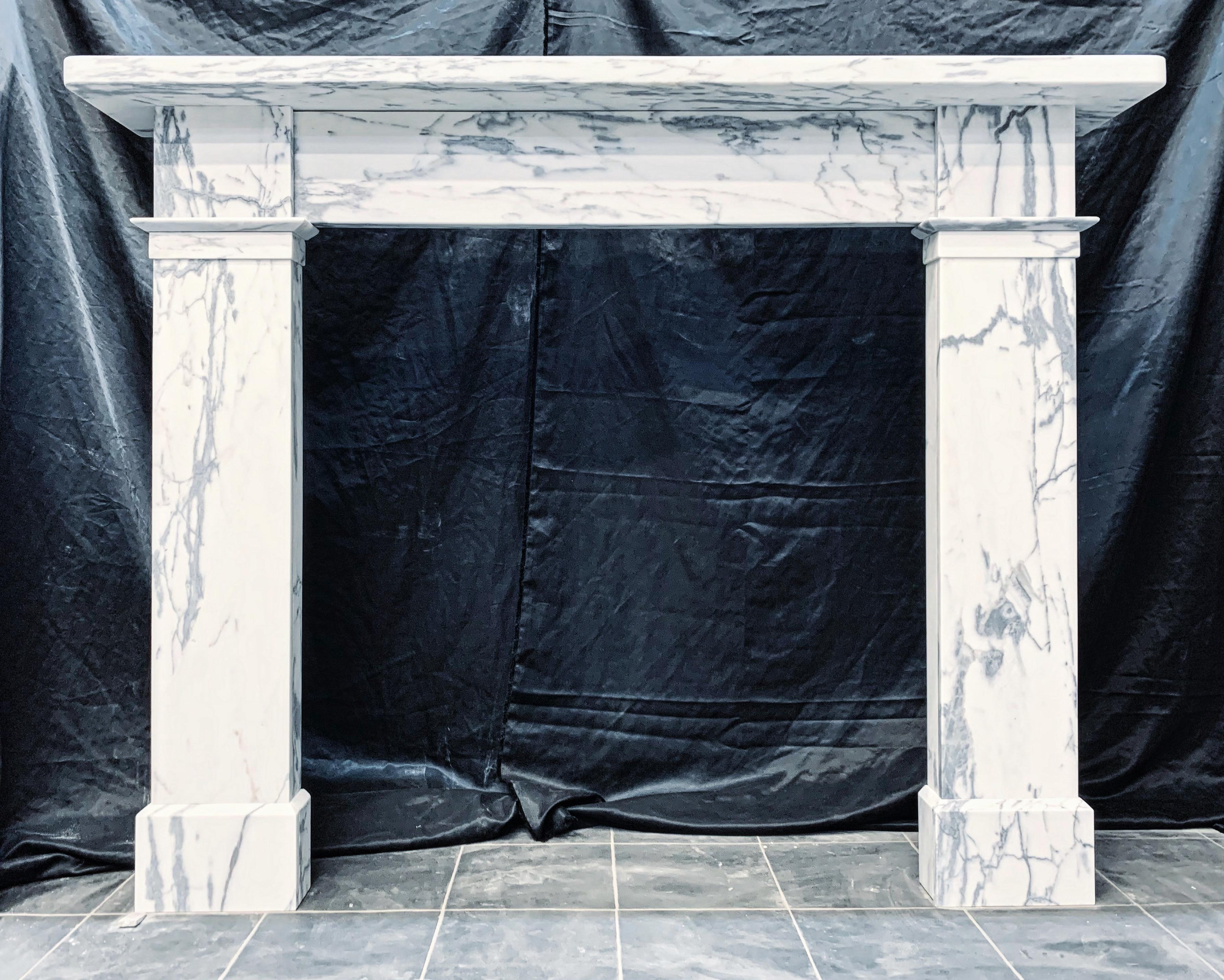 A generous sized 19th Century Victorian Calacatta marble fireplace surround. The thick square edged shelf over an unadorned frieze, flanked by wide and tall jambs with intermittent block and splayed moulding at the base frieze line level, all