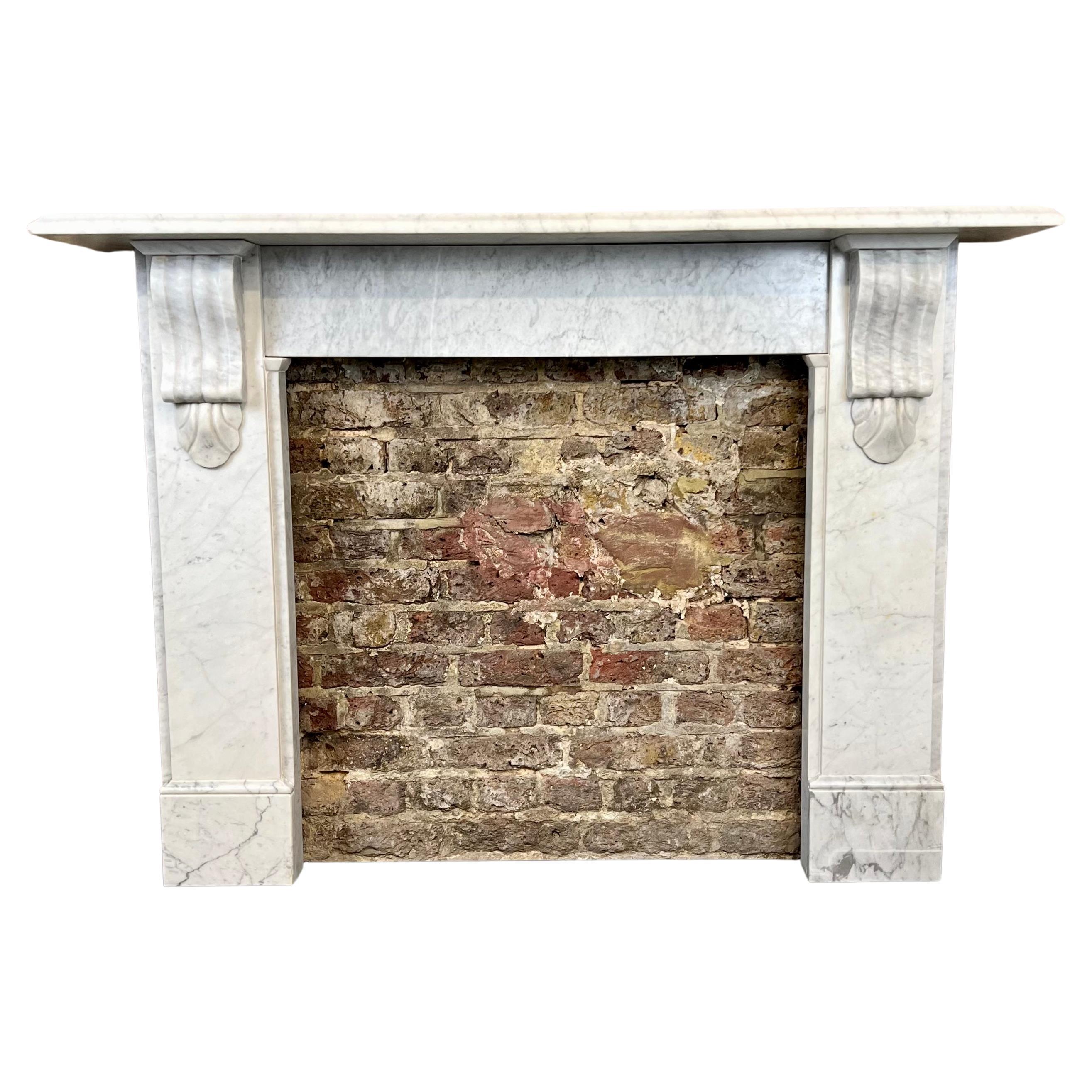 19th century Victorian Carrara marble fireplace mantlepiece.
This antique fireplace surround made from Italian Carrara marble has is predominantly white with evenly grey veins throughout. Made in England circa 1850 - 1880 has recently been salvaged