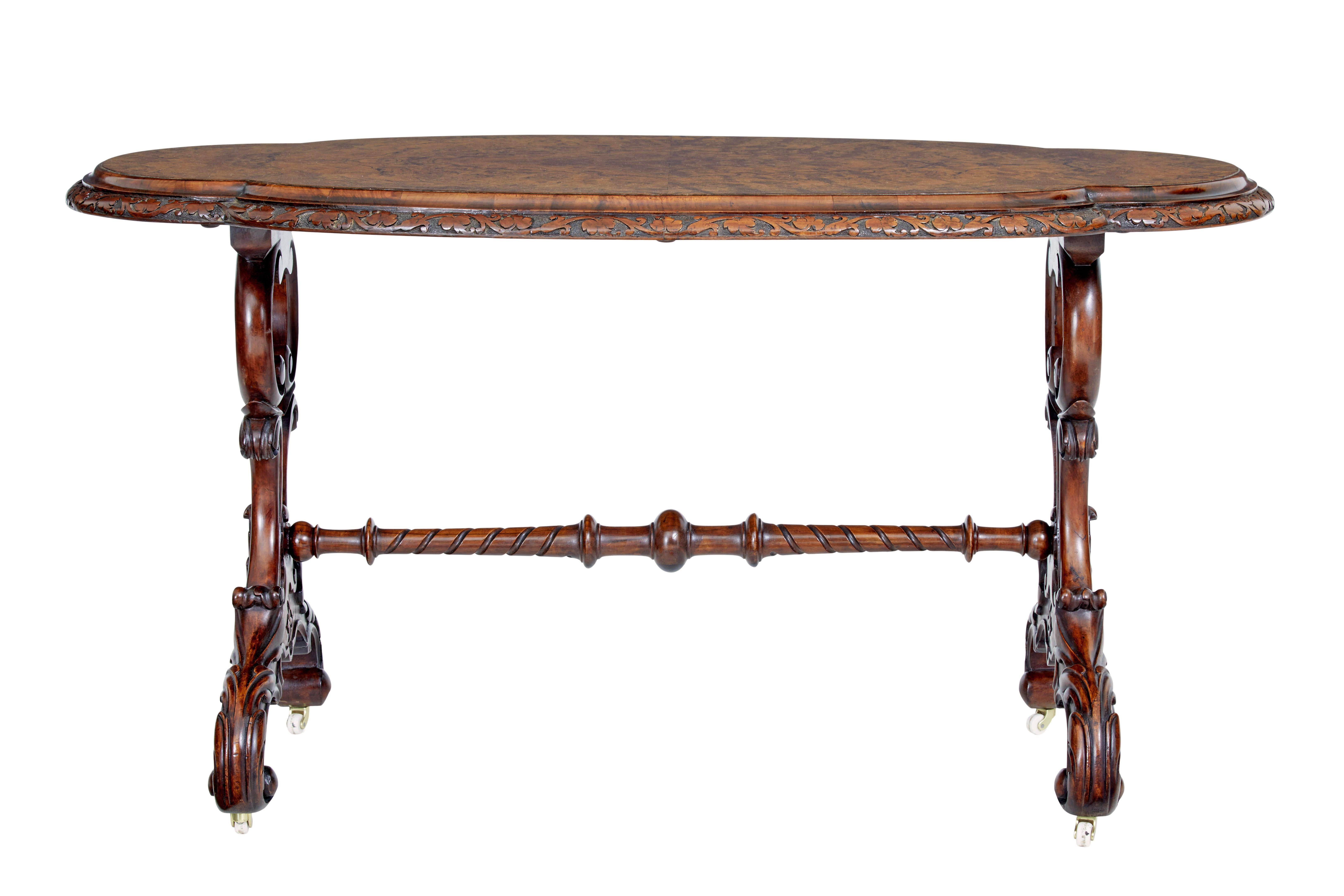 Victorian carved oval occasional table, circa 1860.

Shaped top with beautifully carved in solid walnut around the edge, quarter veneered burr walnut top surface. Standing on a pierced and carved base. United by stretcher.

Raised on original