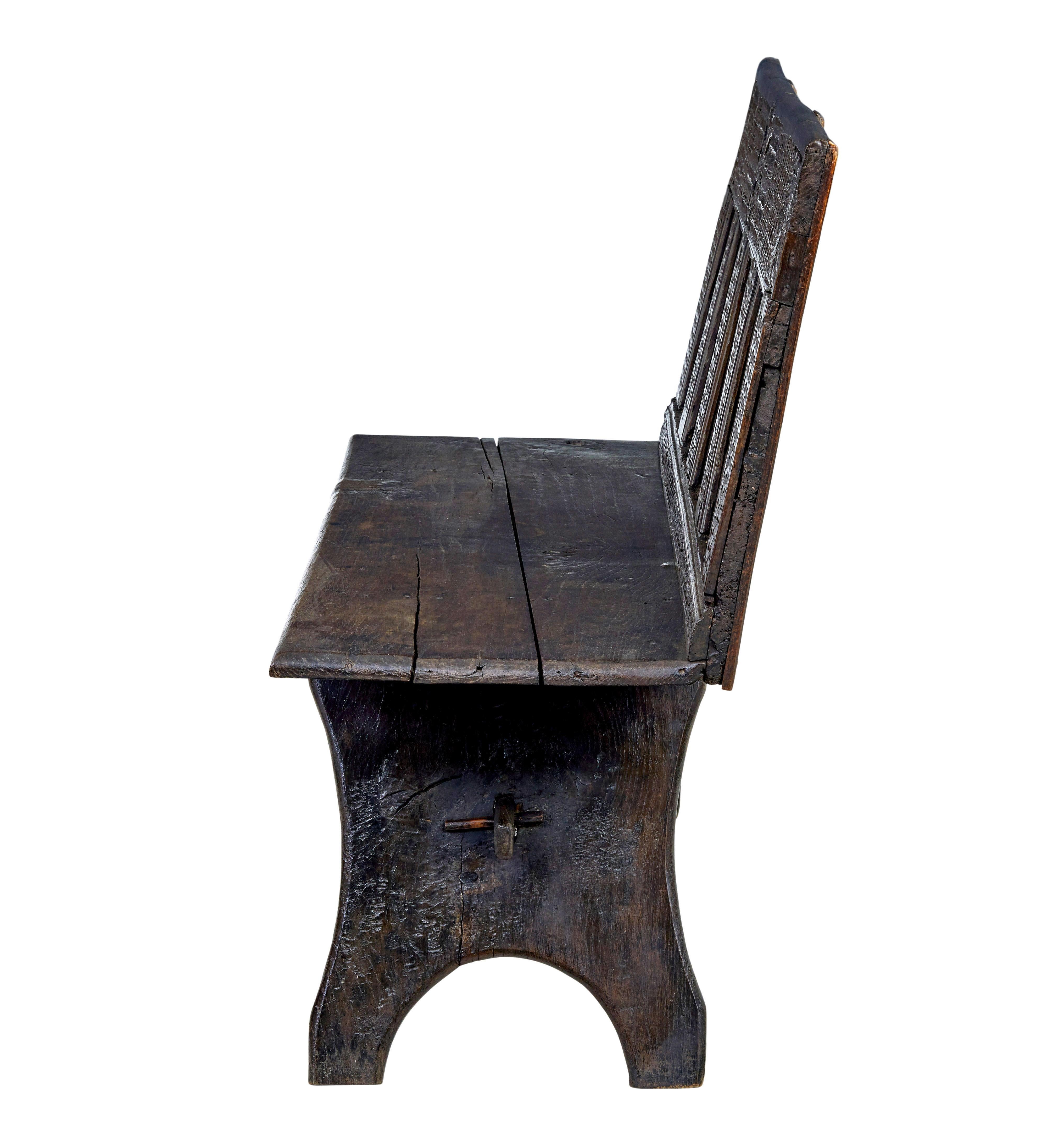 19th century Victorian carved oak bench circa 1890.

Victorian bench made from earlier elements, named and dated 1775.  Pegged base supports elements from an 18th century coffer, the victorians were well known for re-purposing and altering period