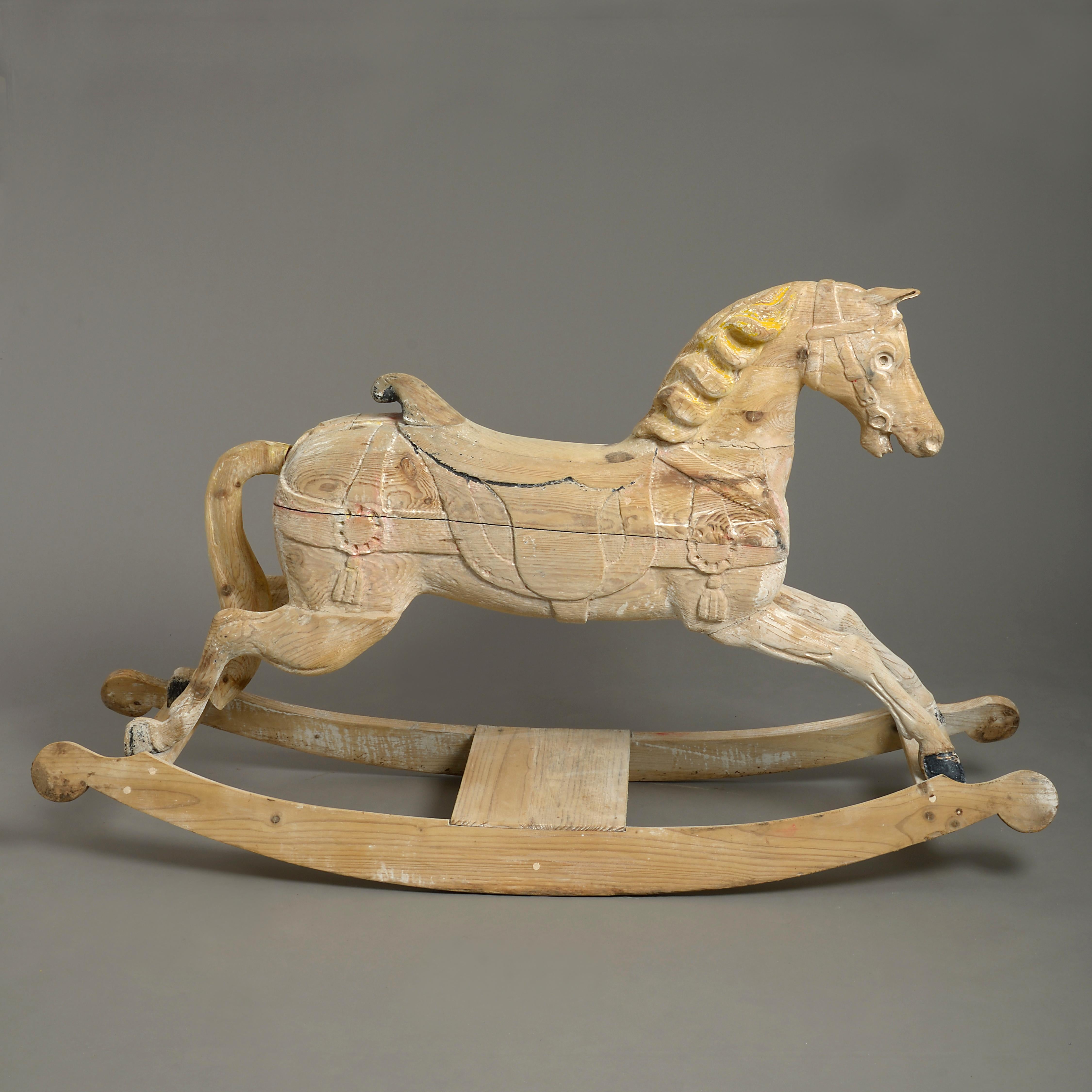 A charming late 19th century Victorian rocking horse, the richly carved galloper once forming part of a carousel or merry go round and now mounted upon wooden rockers. Retaining traces of the original paint.
 
  